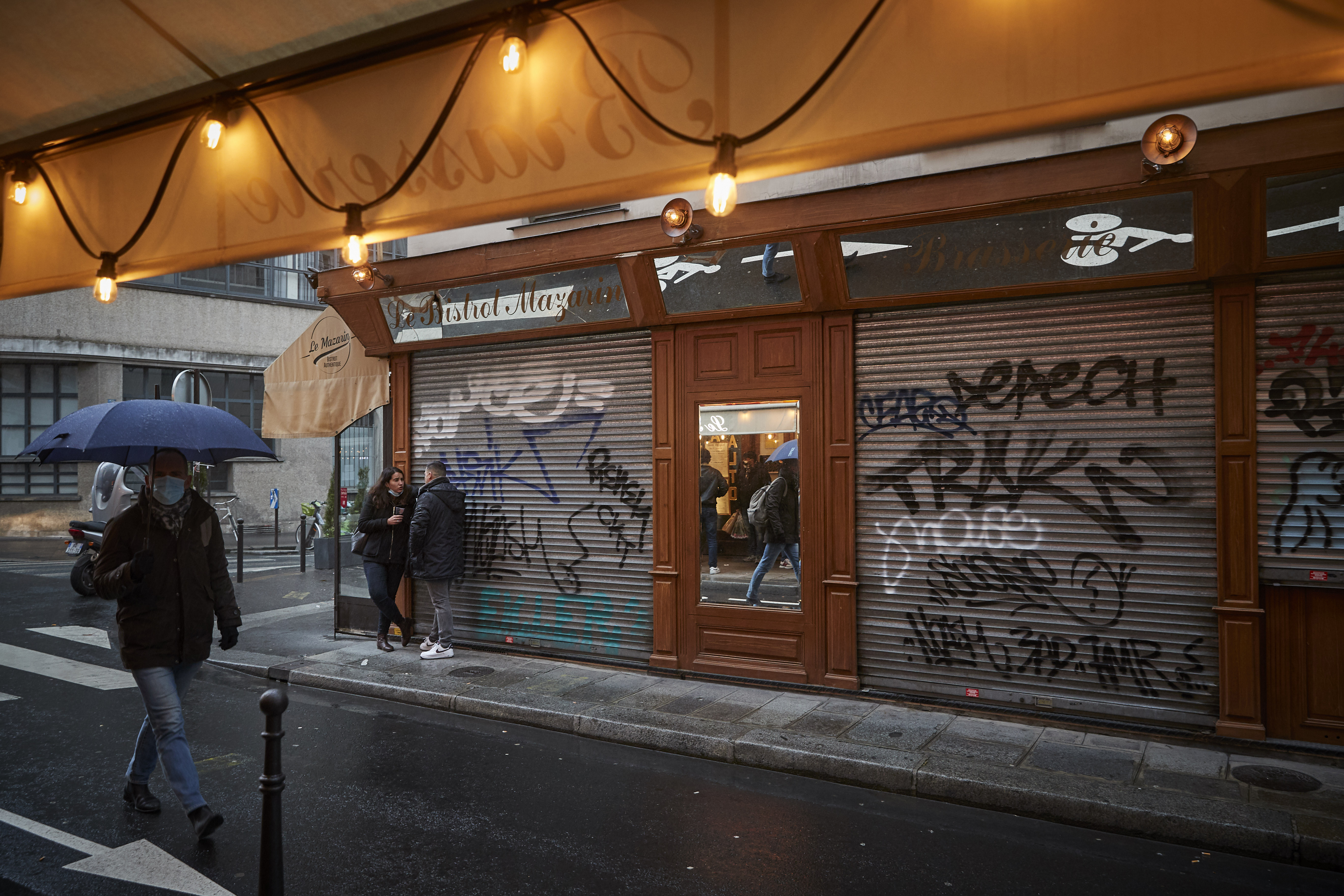 Parisians drink in front of a closed Bistro on March 18, 2021 in Paris, France.