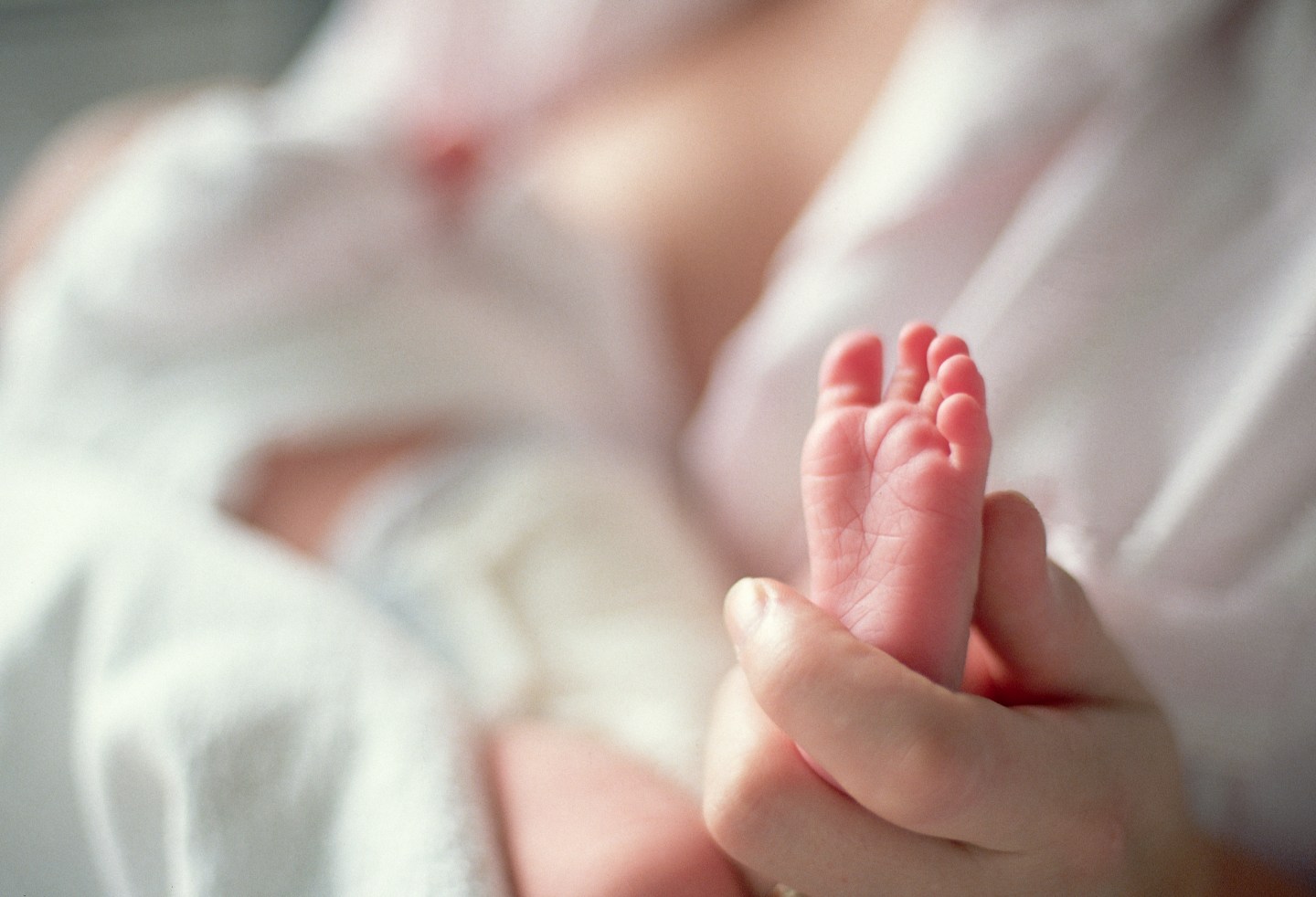 Mother Holding Newborn's Tiny Foot