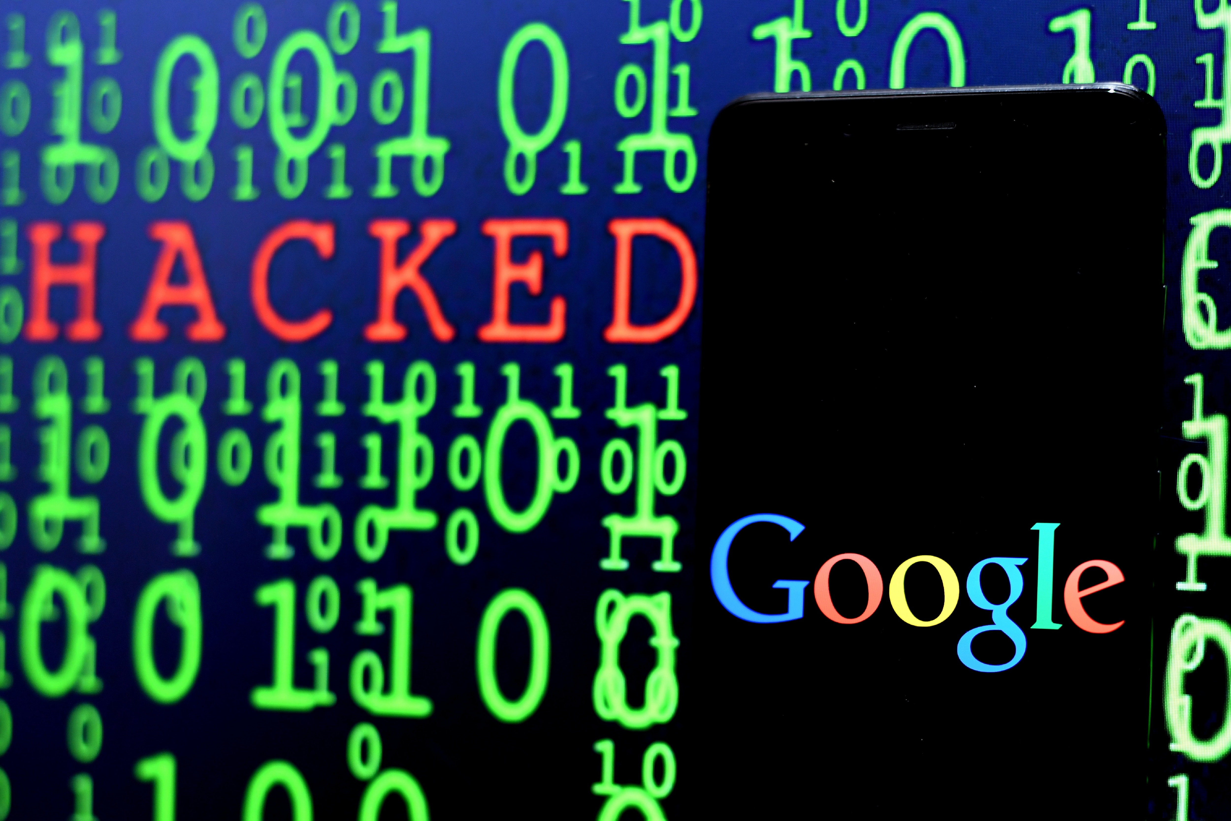 In this Photo illustration, the Google logo seen displayed on a Smartphone with the word hacked in the background.