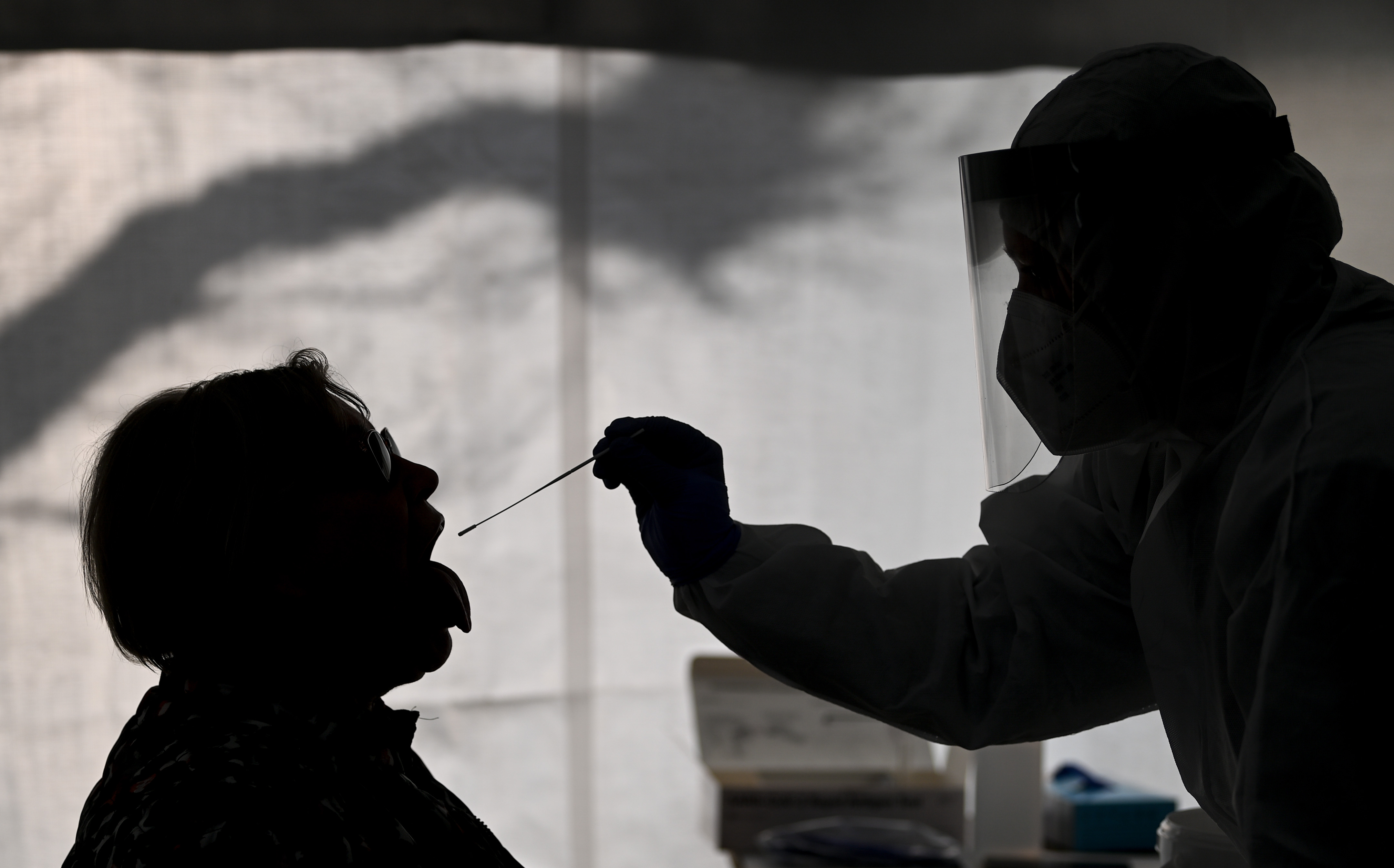 A woman undergoes a Corona quick test in a test tent on the market. A new study says large numbers of those who have been infected with COVID-19 also report new mental health or neurological conditions.