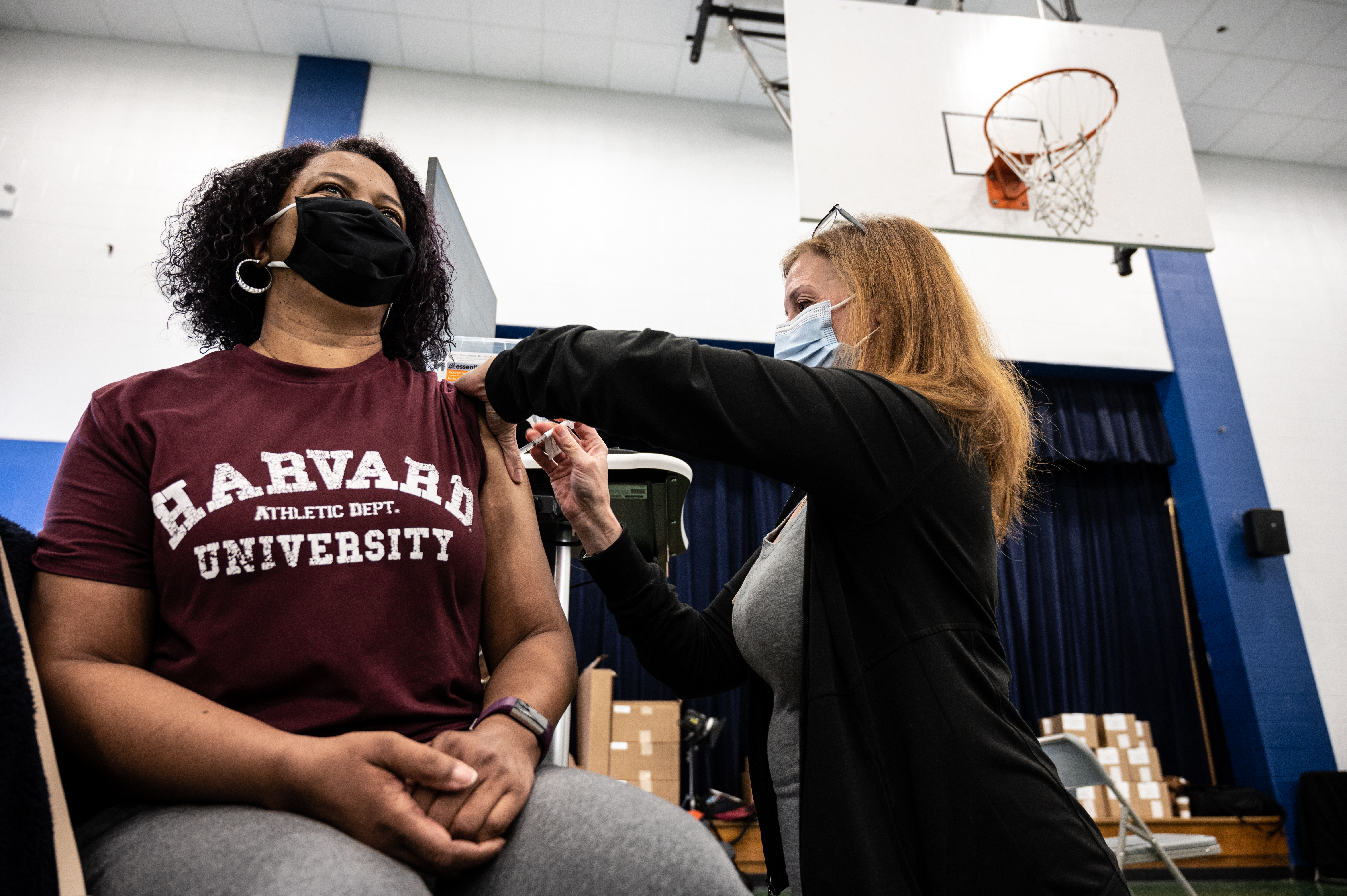 Kimberly Dozier receives her COVID-19 vaccine from a nurse at Whitney M. Young Elementary School on April 2, 2021 in Louisville, Ky.