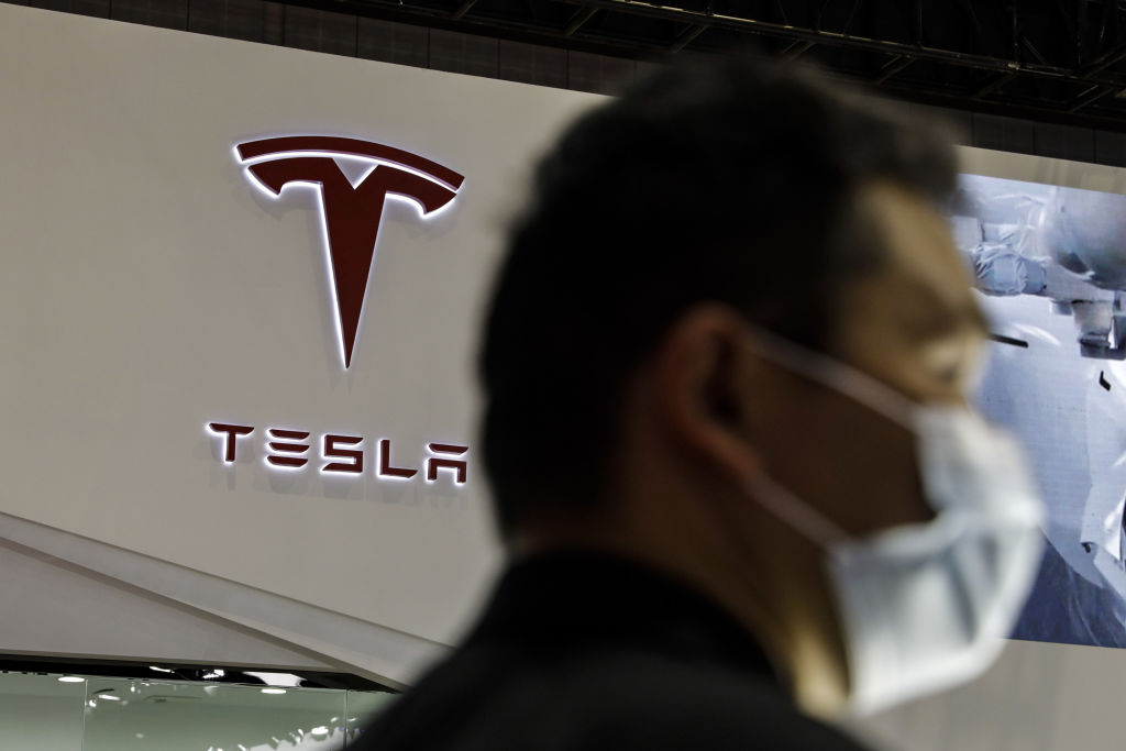 A woman stood on top of a Tesla in protest at the Shanghai Auto Show on Monday, bringing unwanted attention to the brand's troubles in China.