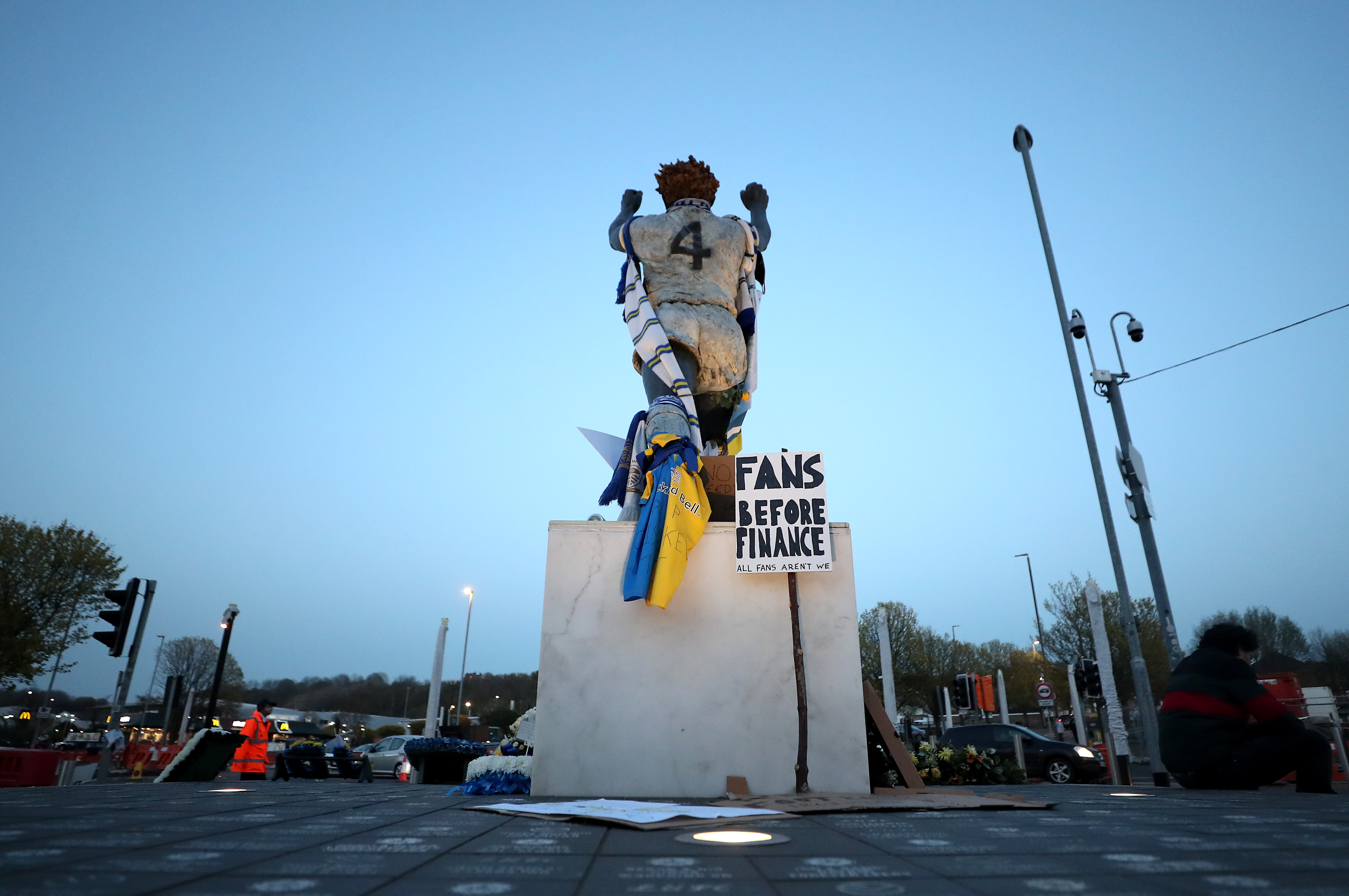 Banners next to the statue of former Leeds United player Billy Bremner, as fans protest against Liverpool's decision to be included amongst the clubs attempting to form a new European Super League.during the Premier League match at Elland Road, Leeds.
