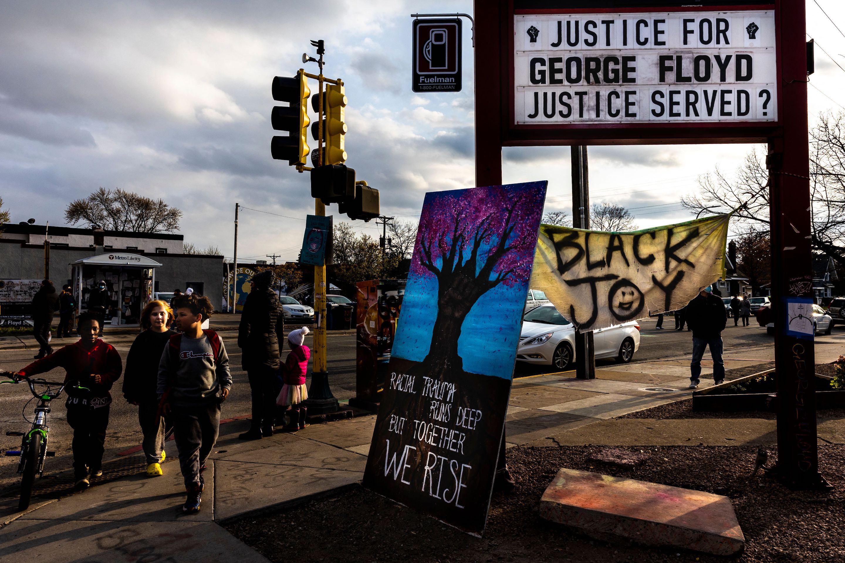 Young boys walk past George Floyd Square in Minneapolis, Minnesota on April 21, 2021, a day after Derek Chauvin was convicted.
