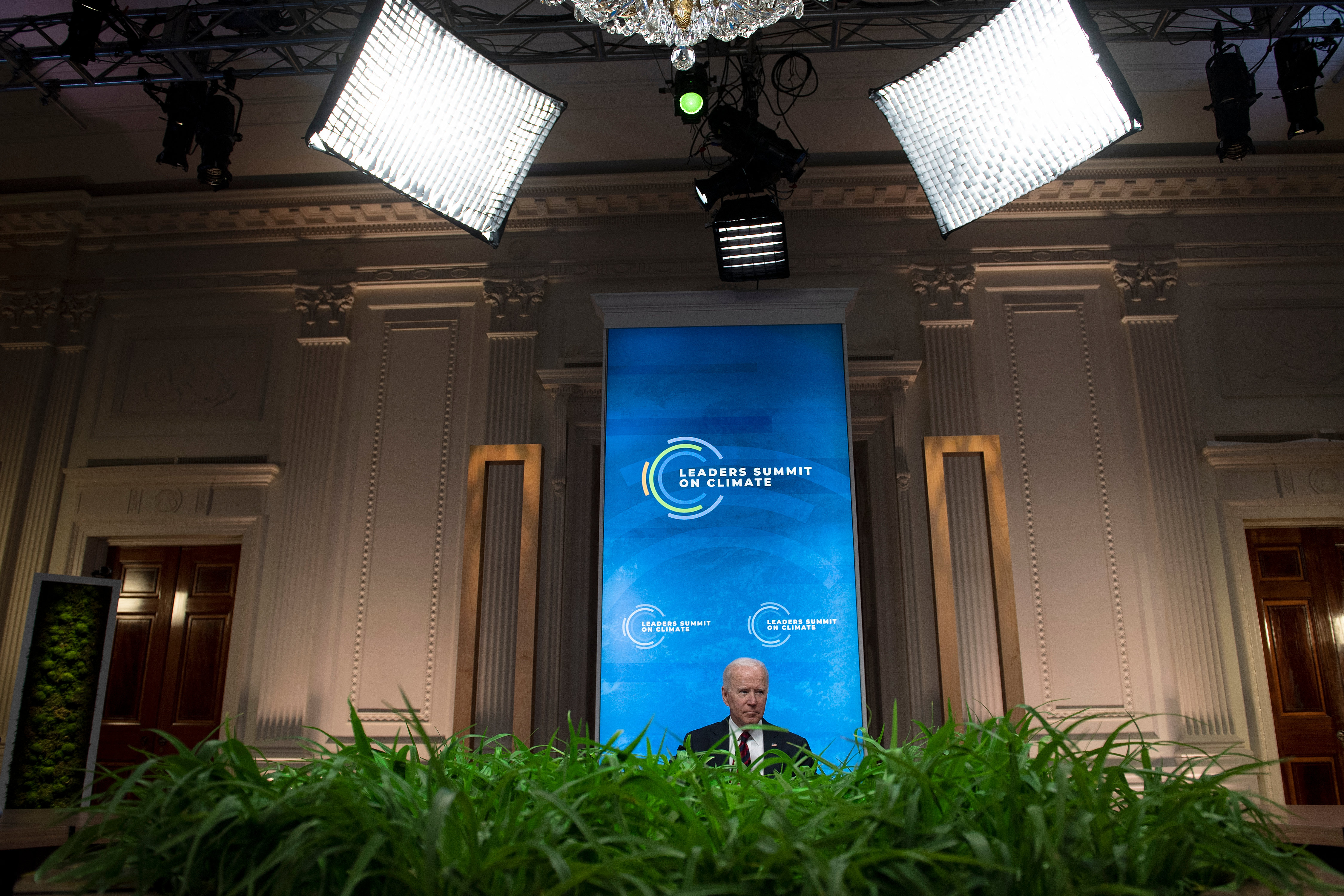 President Joe Biden on Thursday sharply ramped up U.S. ambitions on slashing greenhouse gas emissions, leading new pledges by allies at a summit he hopes brings the world closer to limiting climate change.