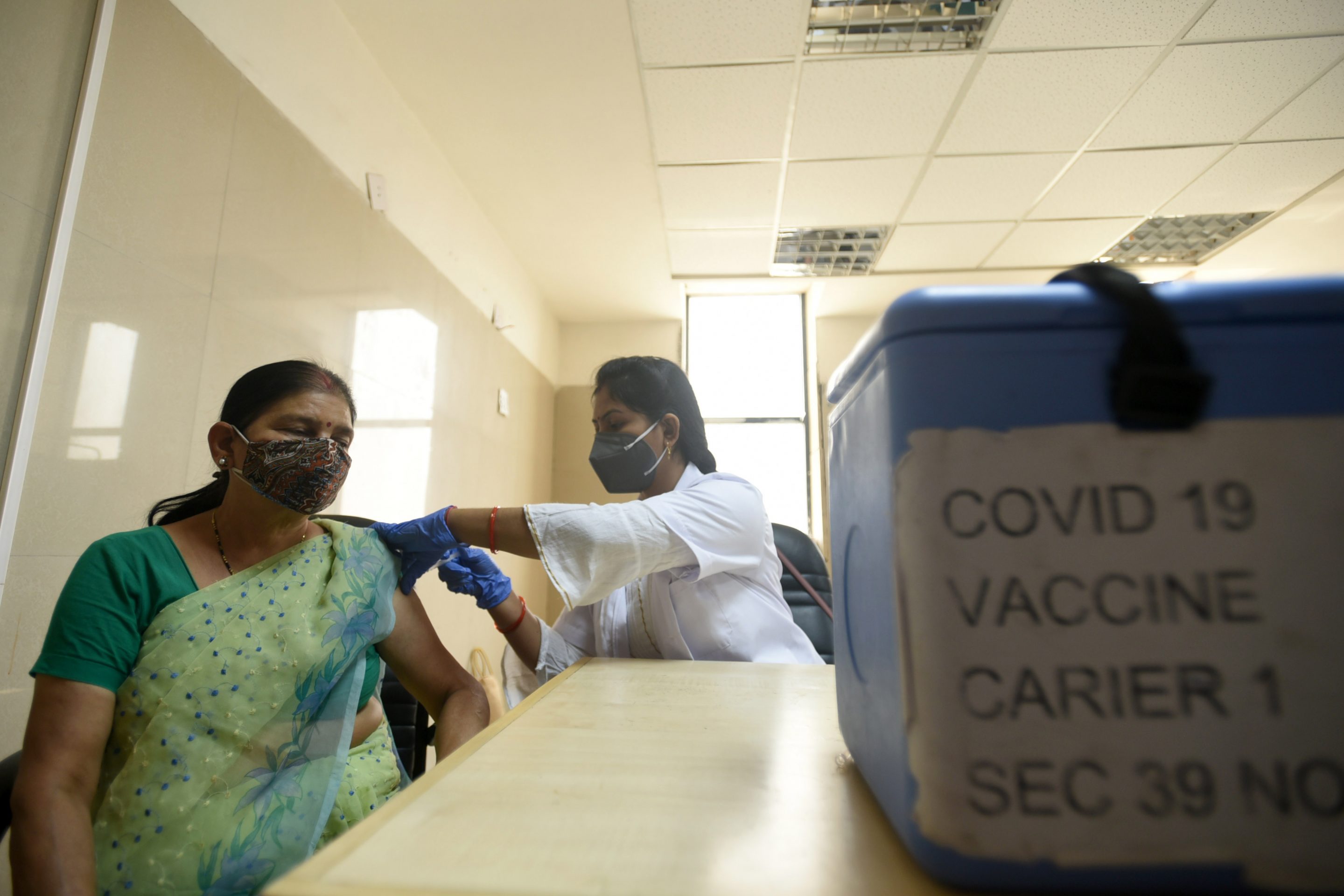 A woman being vaccinated against COVID-19 at a hospital in Noida, India. "The rapid development of COVID-19 vaccines has been one of the greatest scientific achievements of the past 50 years," write the authors. "The challenge we now face is to ensure they also become one of our greatest humanitarian and public health achievements."