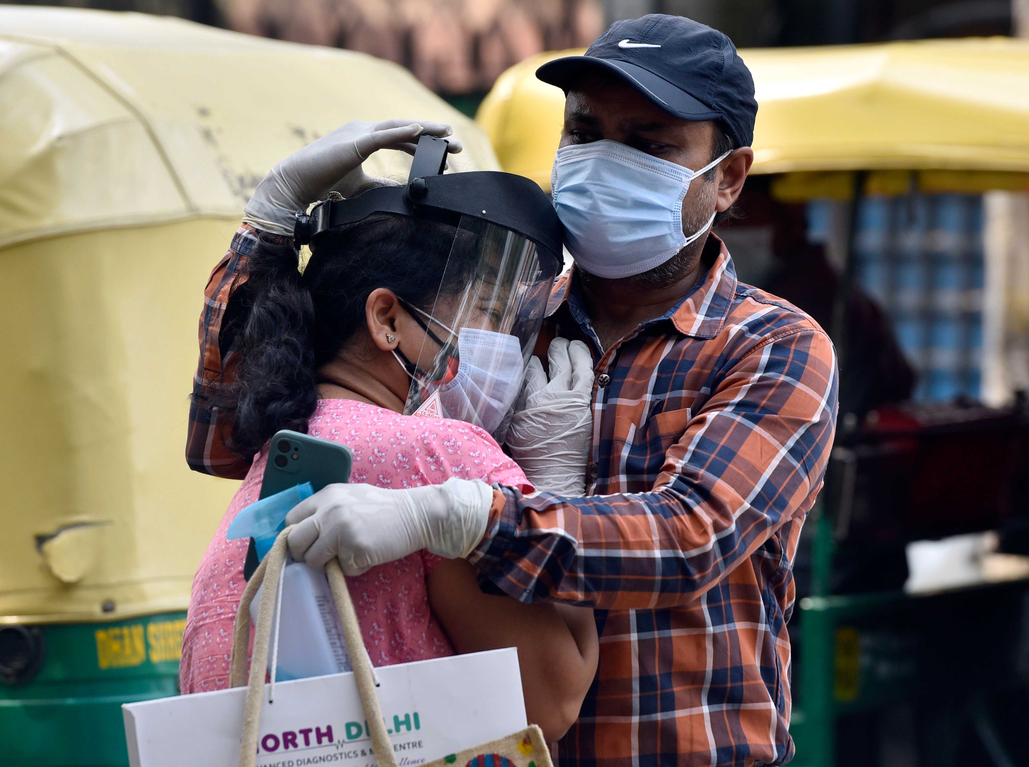 A woman is consoled after her father is unable to gain admission to Lok Nayak Jai Prakash Narayan Hospital, on April 29, 2021, in New Delhi.
