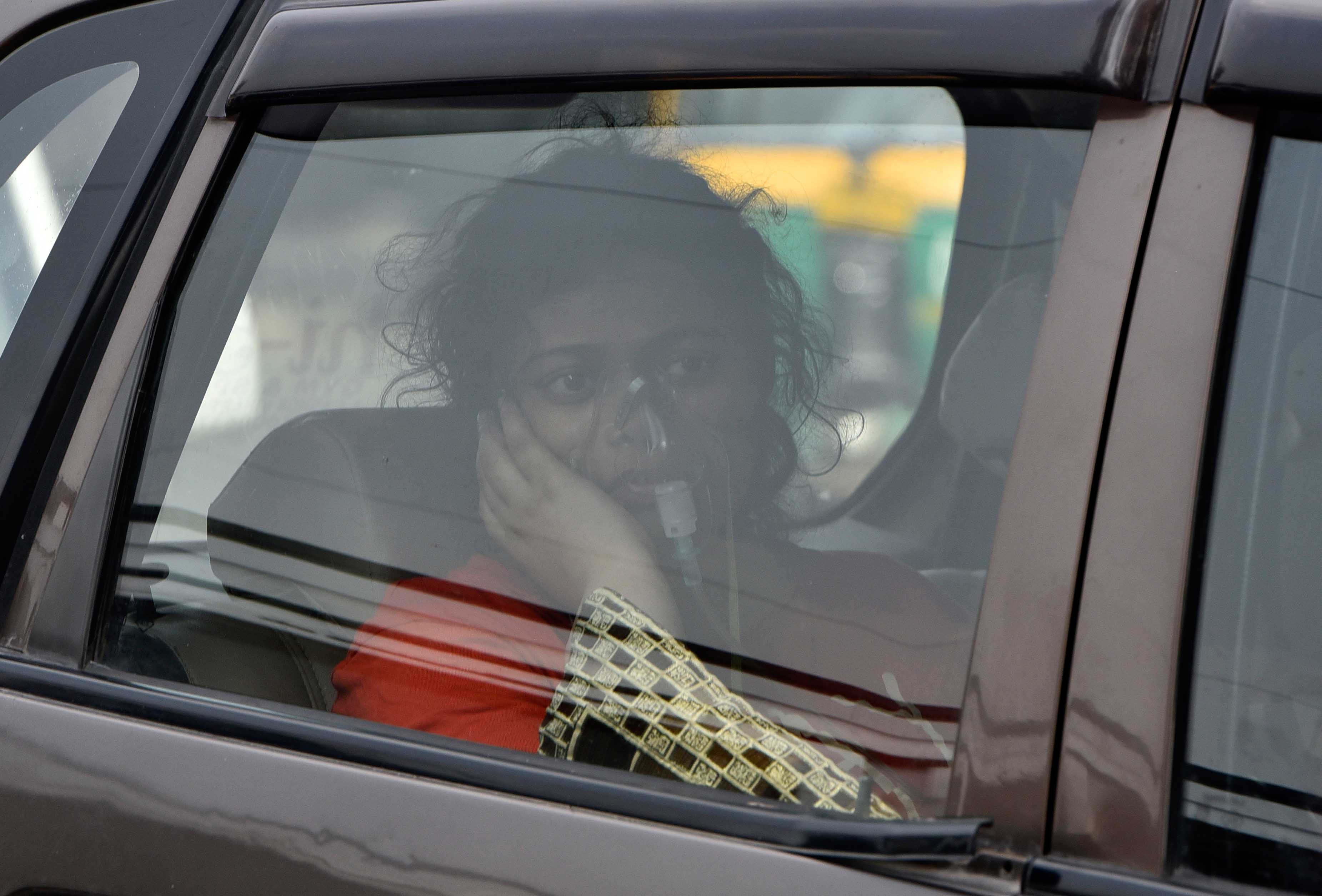 A woman on oxygen support seen waiting in a car outside the Covid-19 ward at Lok Nayak Jai Prakash (LNJP) hospital, on April 29, 2021 in New Delhi, India.