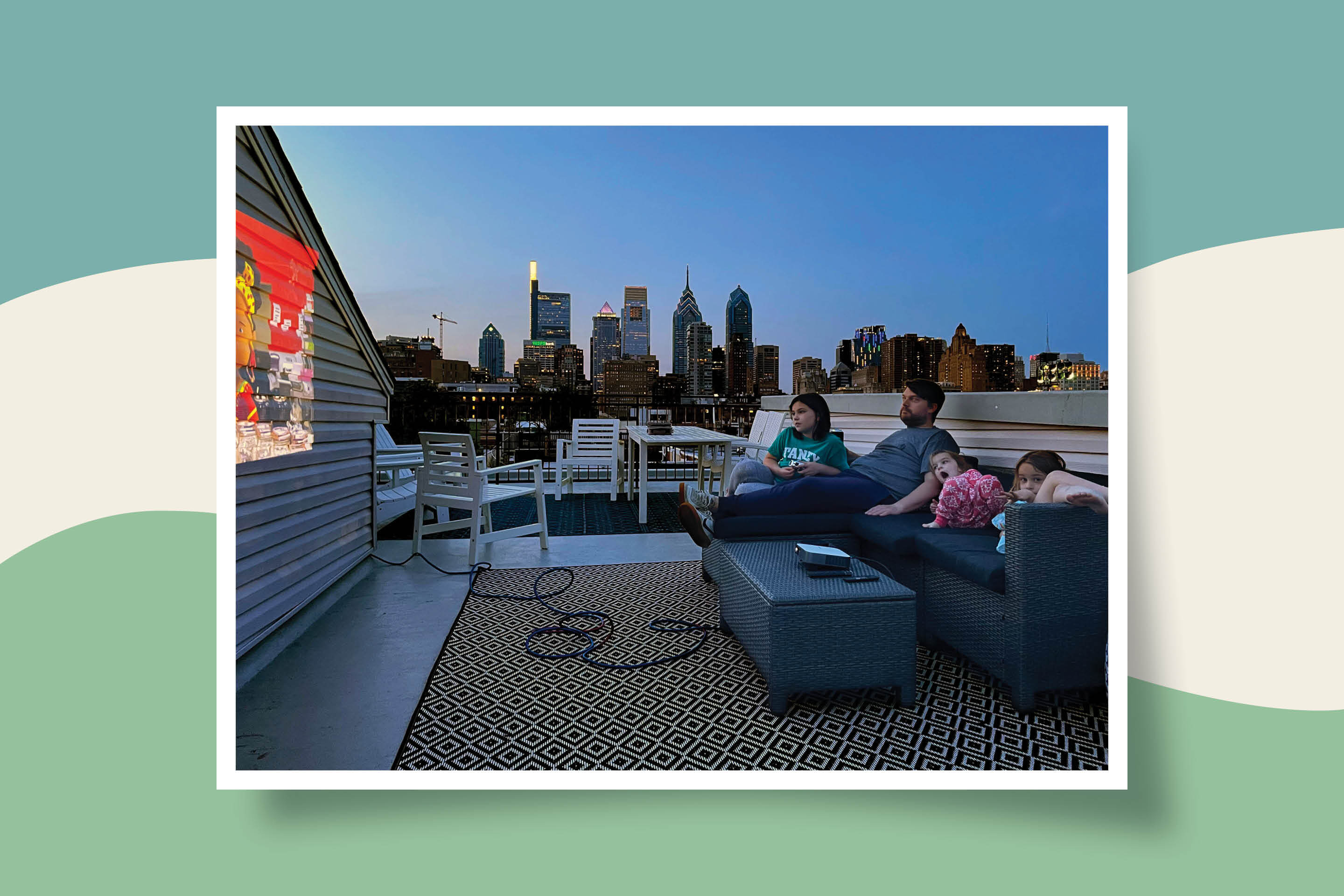The Stephens family using the ViewSonic M2e Smart Wi-Fi Portable Projector.
