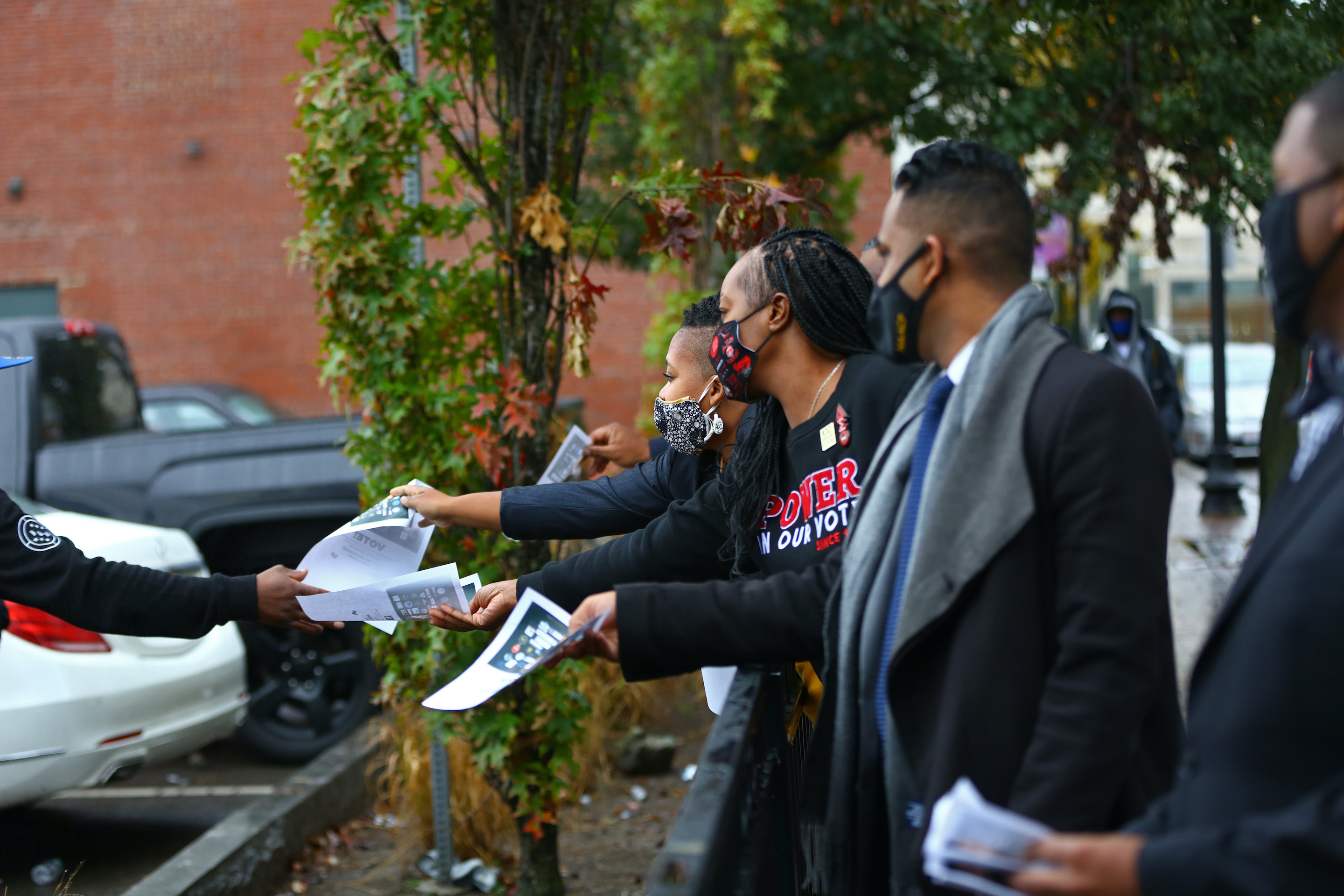 Members of the 1619 Project, organized by the Urban League of Eastern Massachusetts, work to get Black voters to the polls in Boston on Oct. 28, 2020. 
