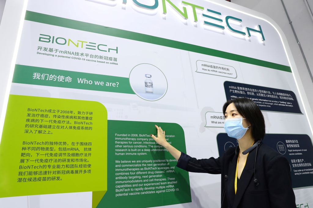A staff member introduces a potential COVID-19 vaccine developed by BioNTech and Fosun Group during the third China International Import Expo (CIIE) in Shanghai on Nov. 5, 2020.