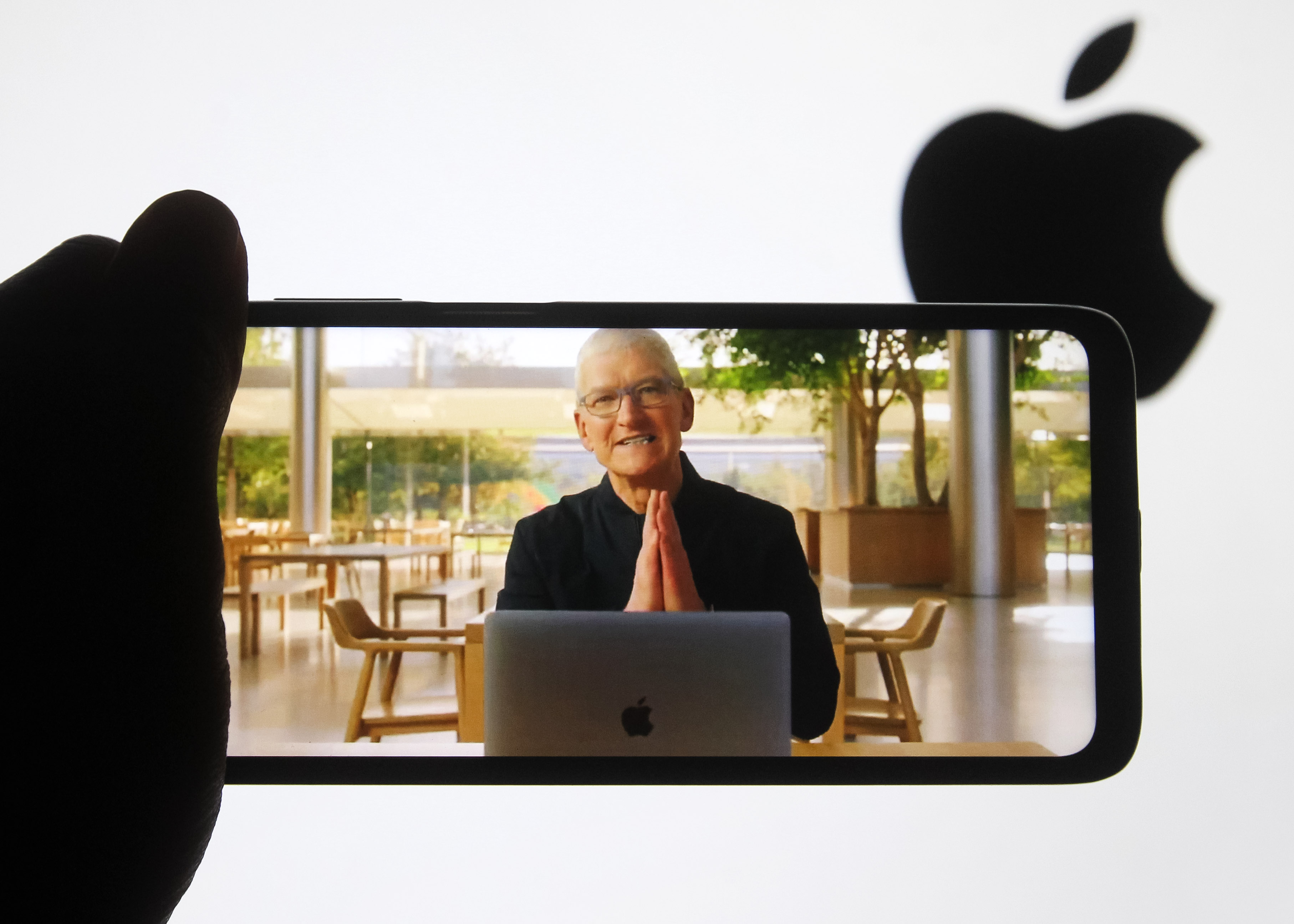 In this photo illustration a screen-grab of CEO Tim Cook making a presentation on a mobile phone screen.