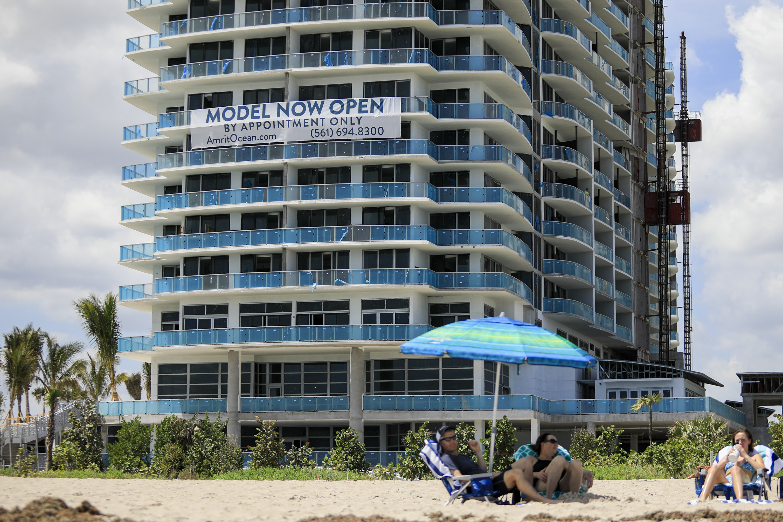 A sign advertises models open for viewing at a condominium building under construction in Riviera Beach, Florida, U.S. All eyes will be on today's pending home sales data.