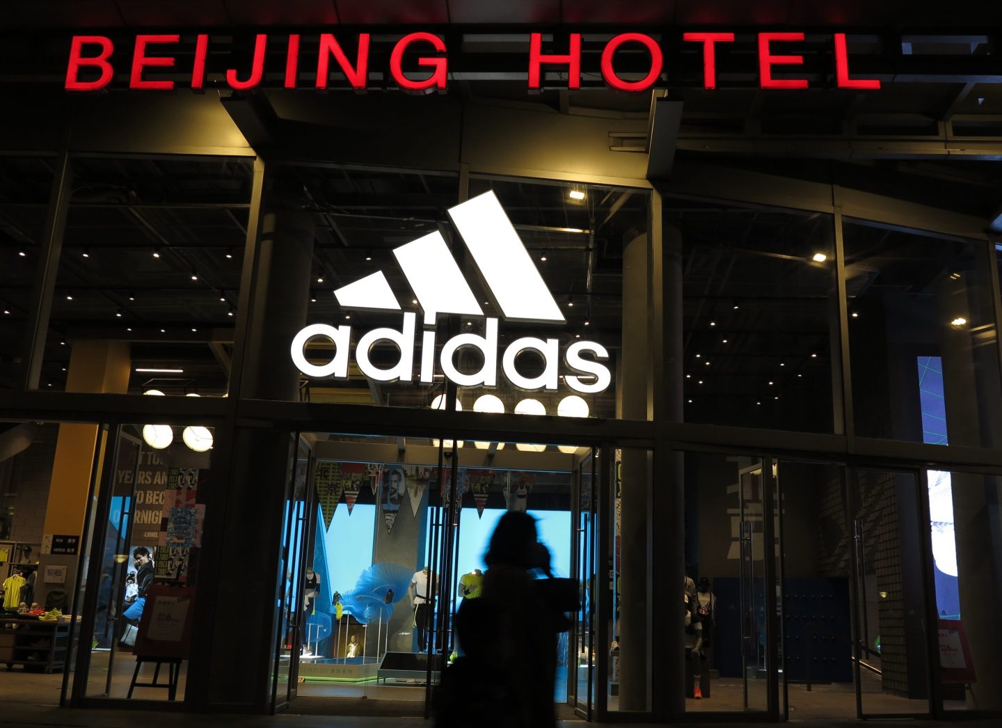 BEIJING, CHINA - APRIL 28, 2021 - Pedestrians pass in front of an Adidas store in the Wangfujing business district in Beijing, China, on April 28, 2021.