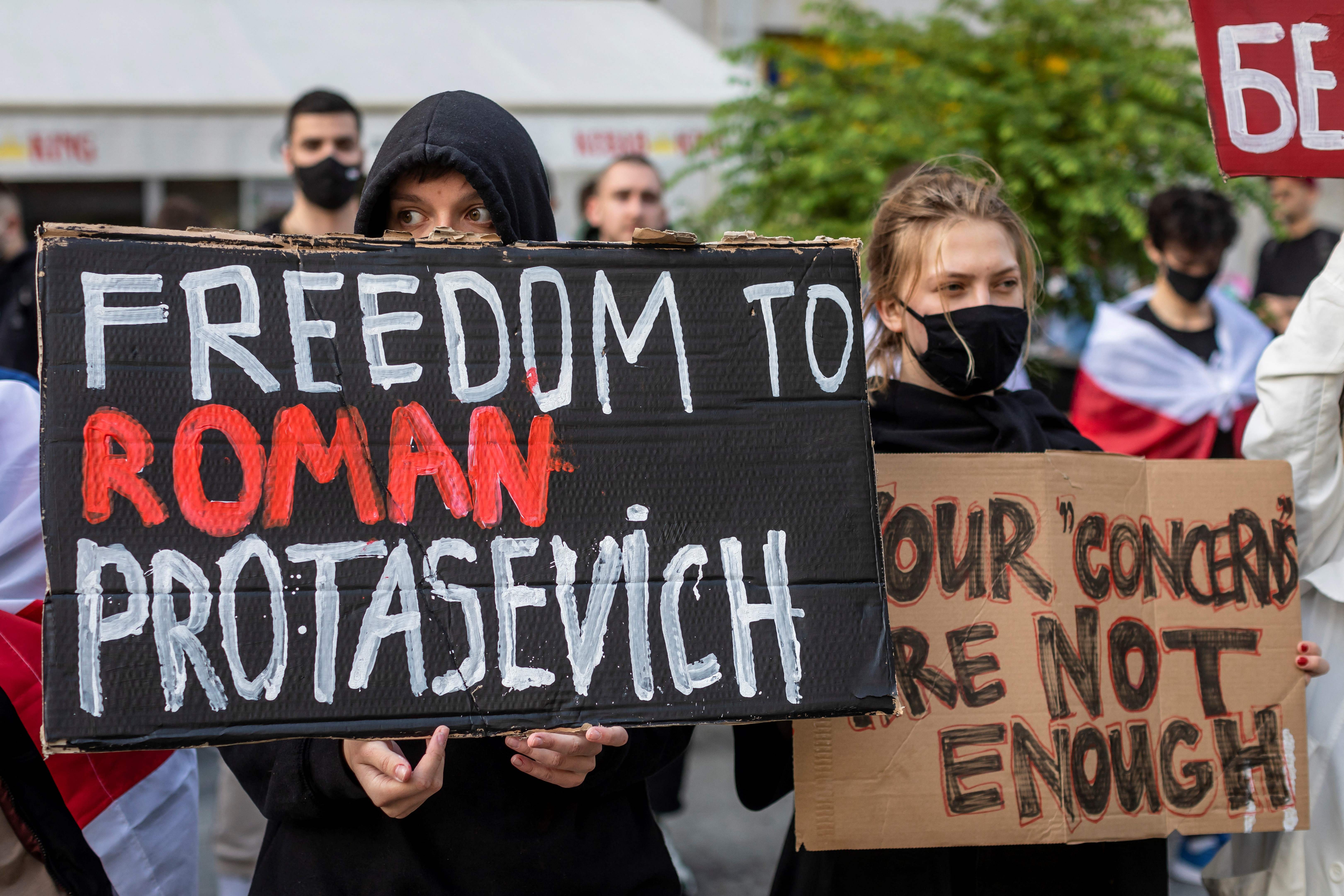 Belarusians living in Poland and Poles supporting them hold up a placard reading 'Freedom to Roman Protasevich' during a demonstration in front of the European Commission office in Warsaw on May 24, 2021.