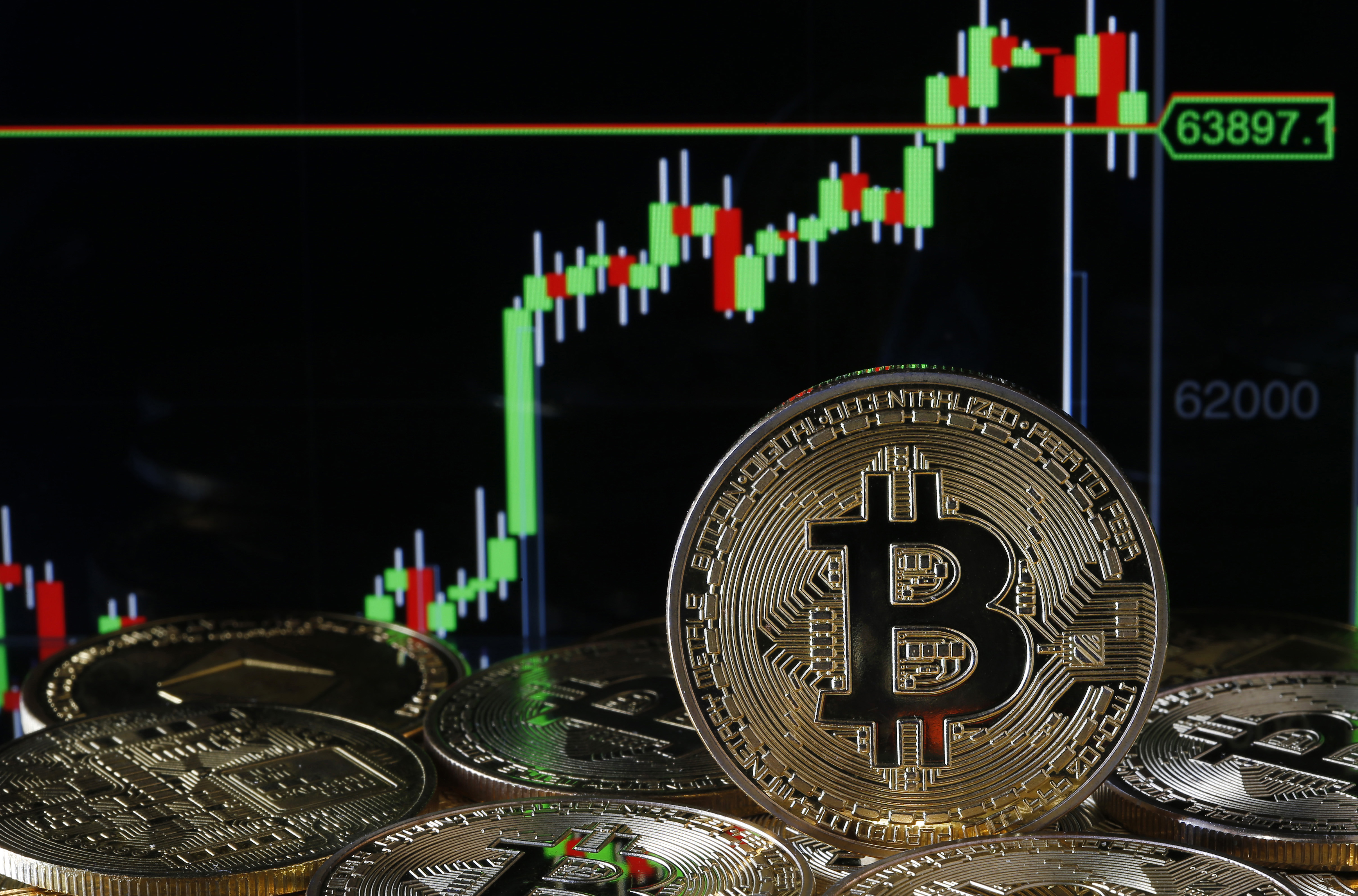 A visual representation of the digital Cryptocurrency, Bitcoin is on display in front of the Bitcoin value graph.