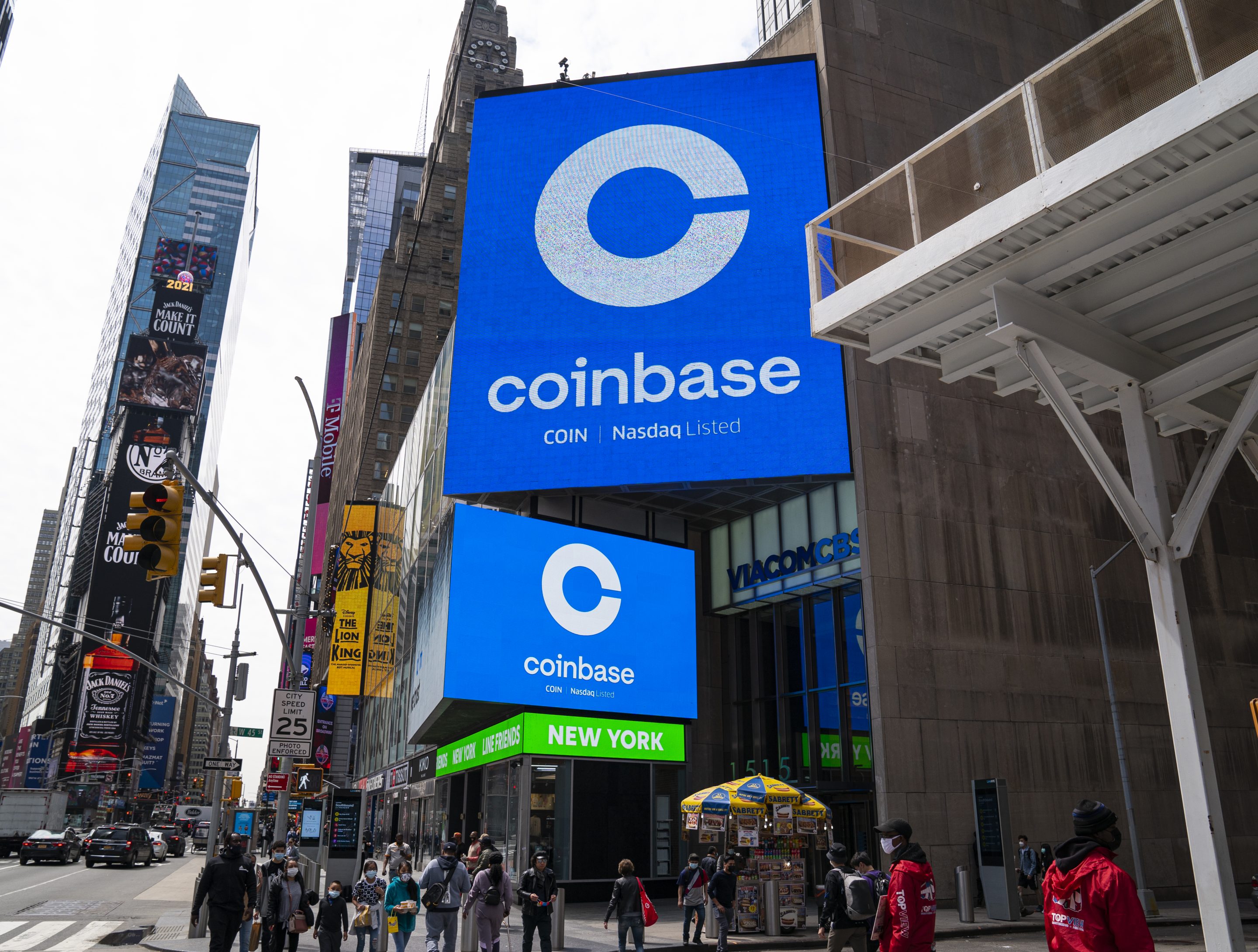 Monitors display Coinbase signage during the company's IPO at the Nasdaq market site on April 14, 2021 in New York City.