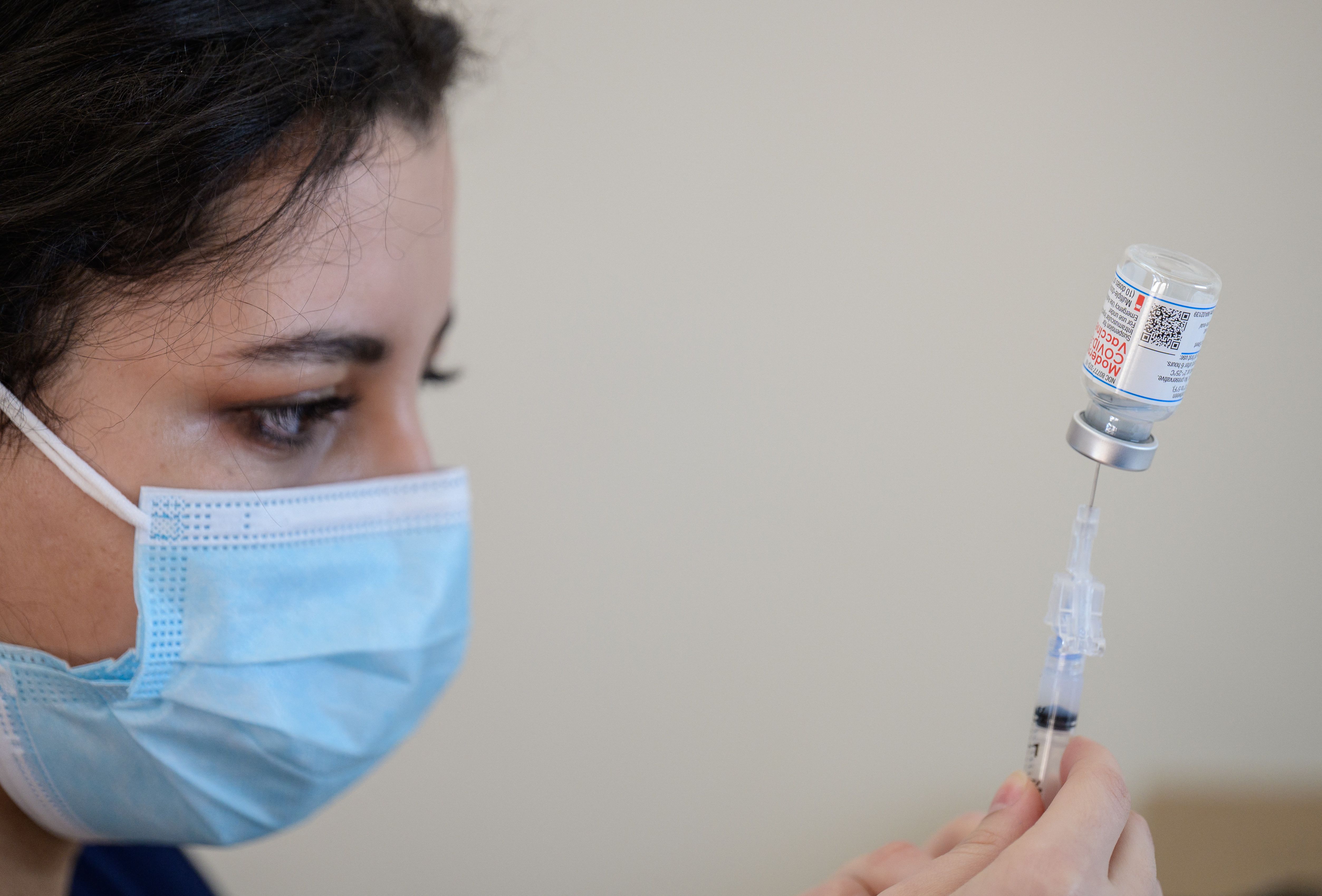 A medical staffer prepares a Moderna COVID-19 vaccine syringe in New York City on April 16, 2021.