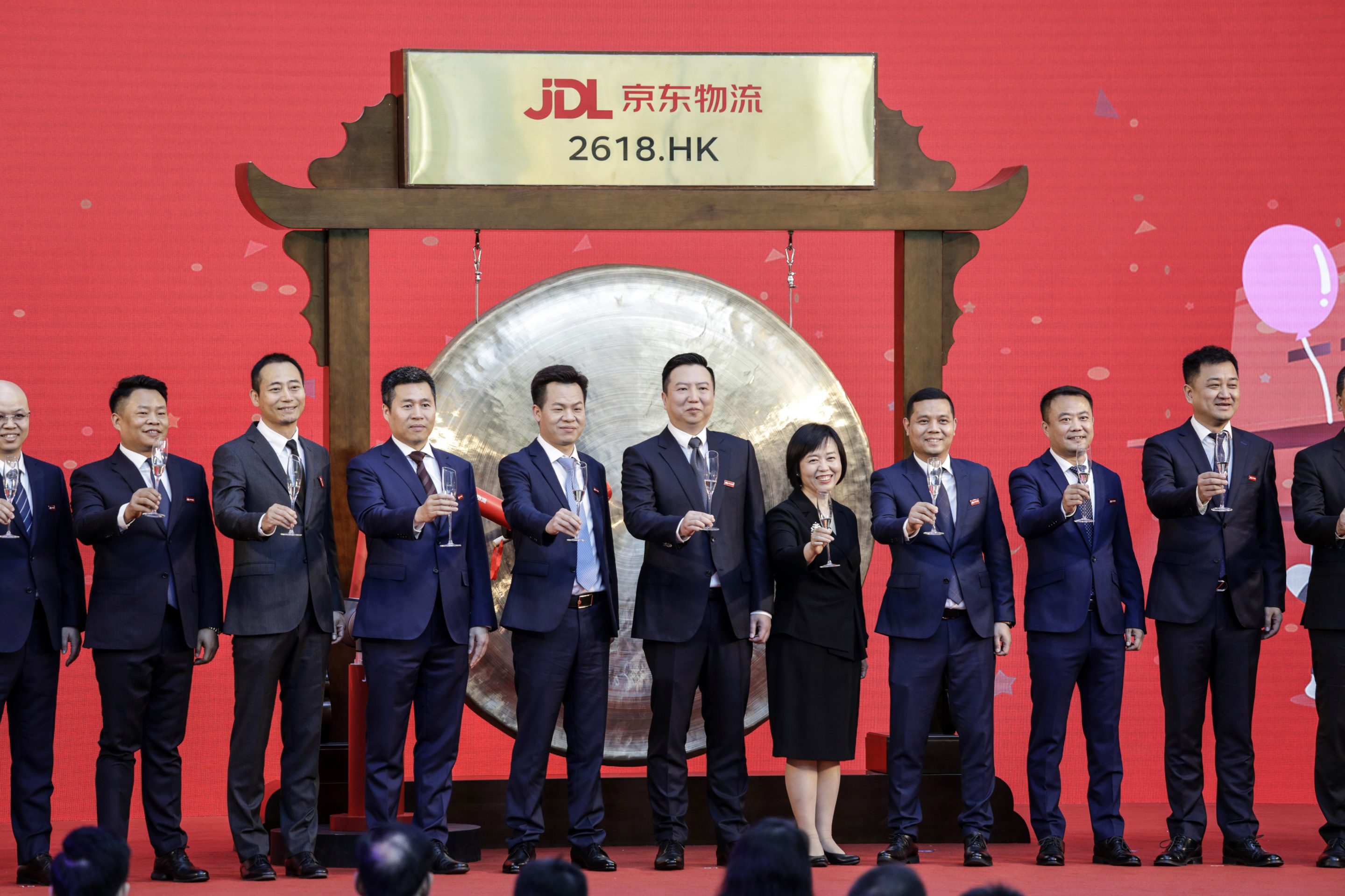 Yu Rui, chief executive officer of JD Logistics Inc., center, stands for photographs with guests during a ceremony marking the debut of JD Logistics on the Hong Kong Stocks Exchange at JD.com Inc. headquarters in Beijing, China, on Friday, May 28, 2021.