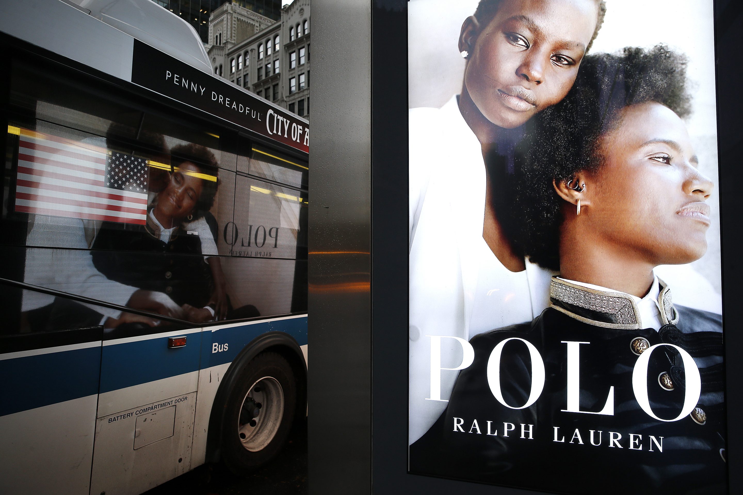 A Polo Ralph Lauren fashion ad is reflected in the window of a city bus in Midtown on November 12, 2020 in New York City.