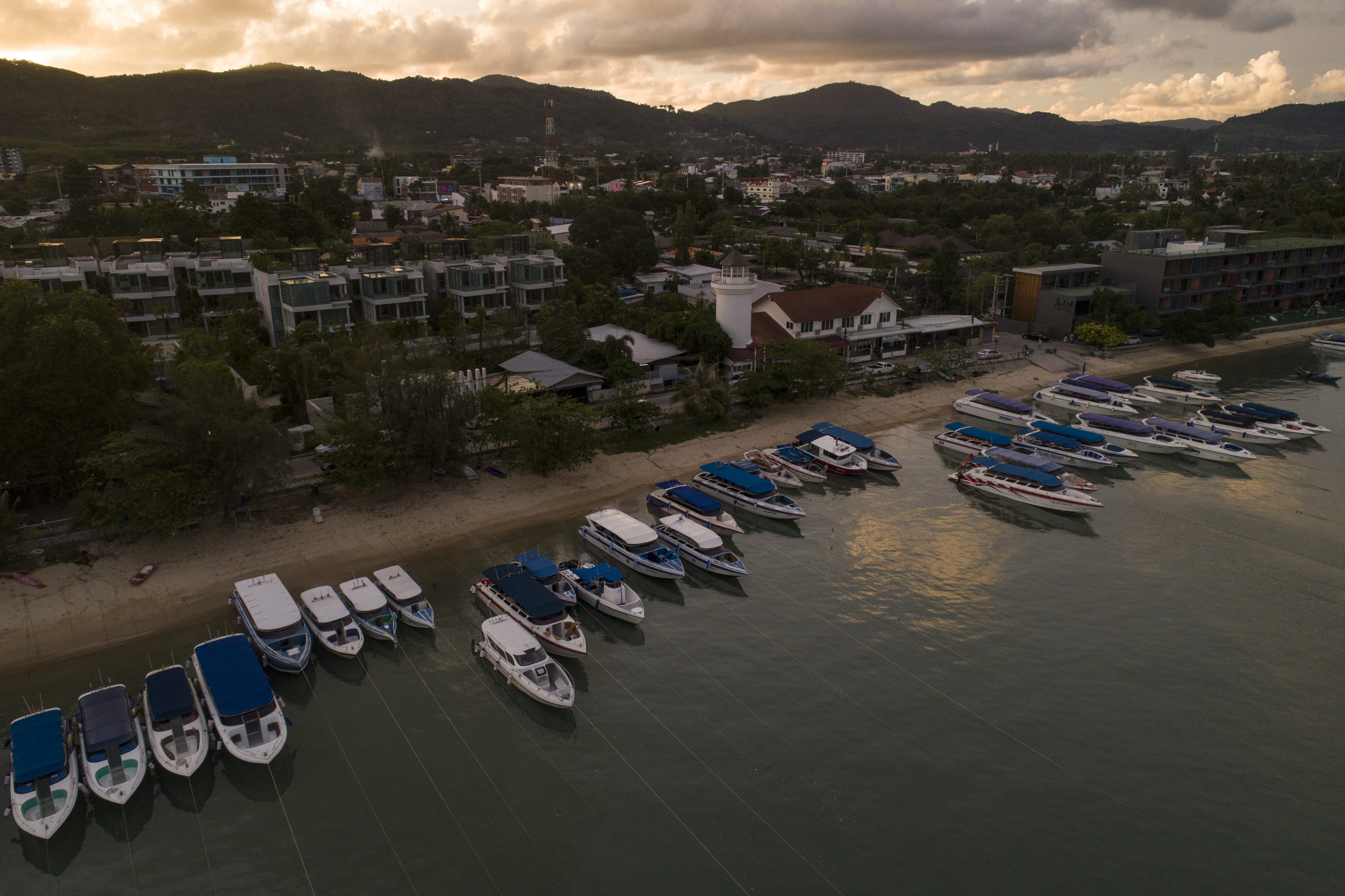 An aerial view of speedboats berthed along the beach at Chalong Pier, the center for day trips to surrounding islands around Phuket on April 21, 2021 in Phuket, Thailand.