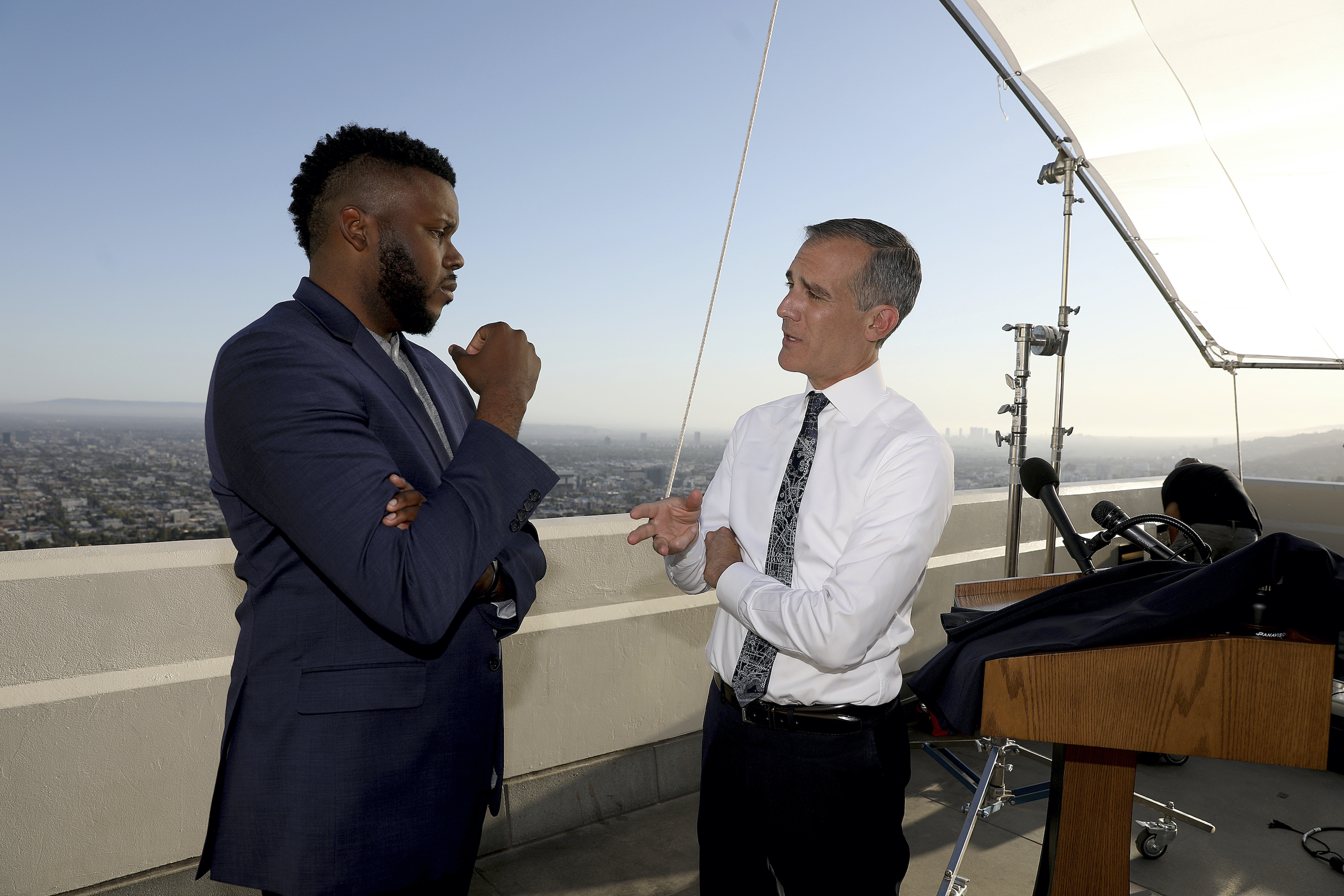 Los Angeles Mayor Eric Garcetti, right, talks with Michael Tubbs, founder of Mayors for a Guaranteed Income.