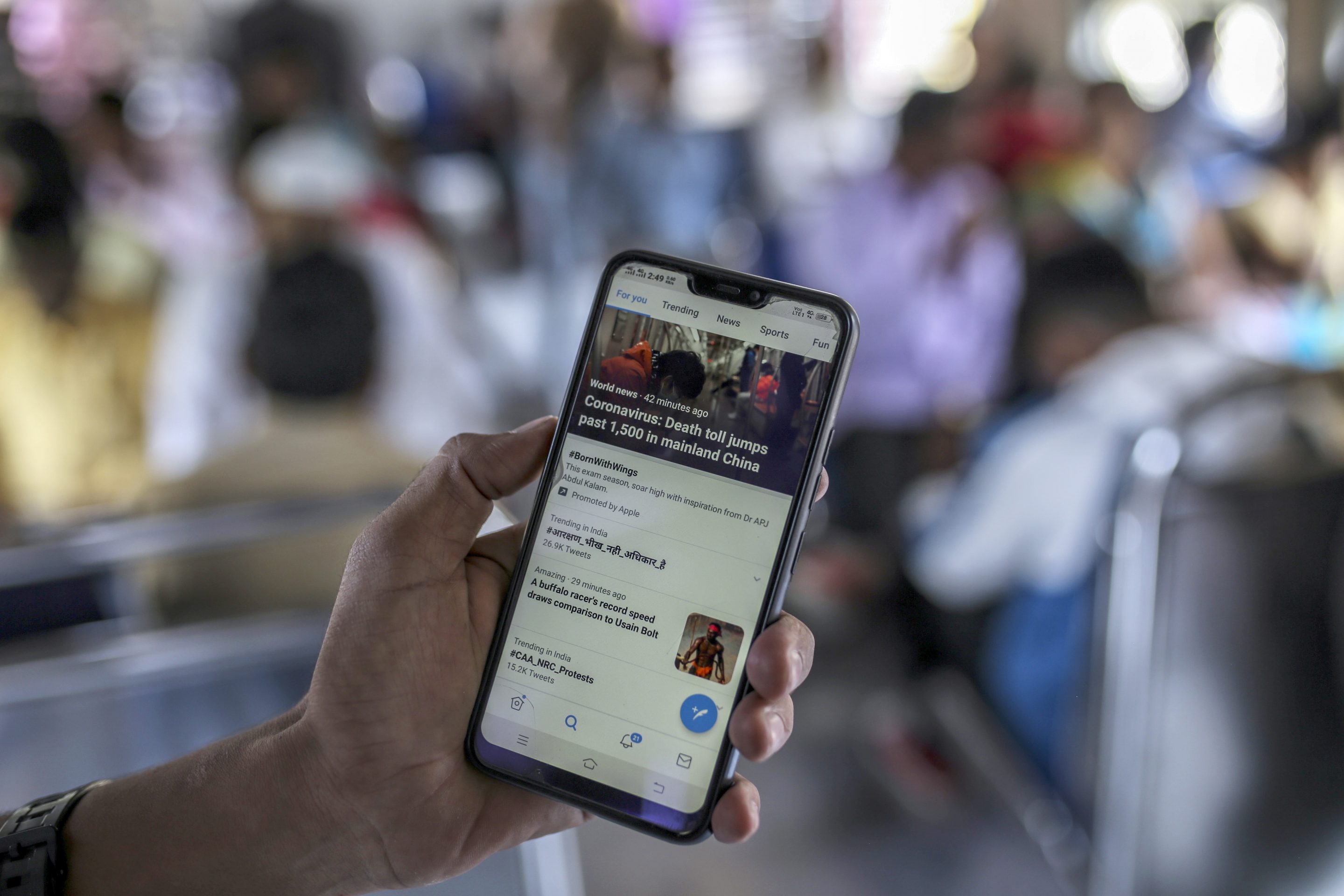 A passenger displays the Twitter Inc. application on a smartphone for a photograph while travelling by train in Mumbai, India, on Saturday, Feb. 15, 2020.