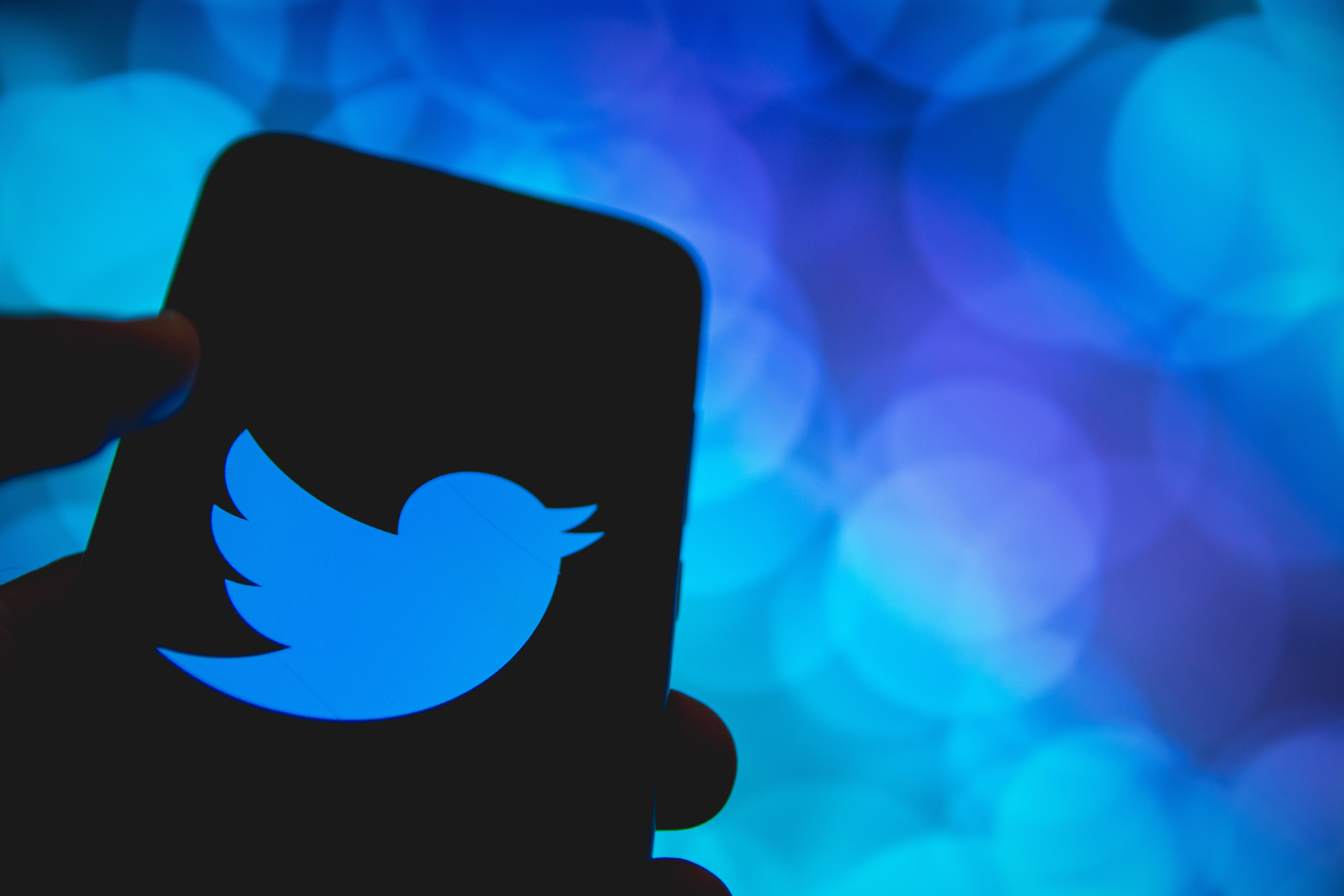 In this photo illustration Twitter logo is displayed on a smartphone screen.