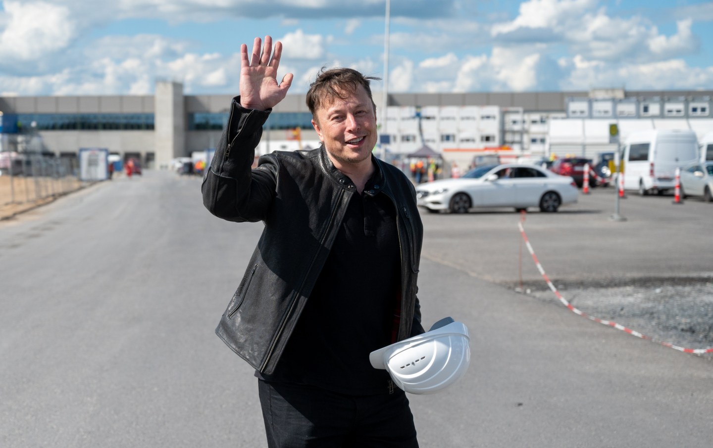 17 May 2021, Brandenburg, Grünheide: Elon Musk, Tesla CEO, stands on the construction site of the Tesla factory and waves.