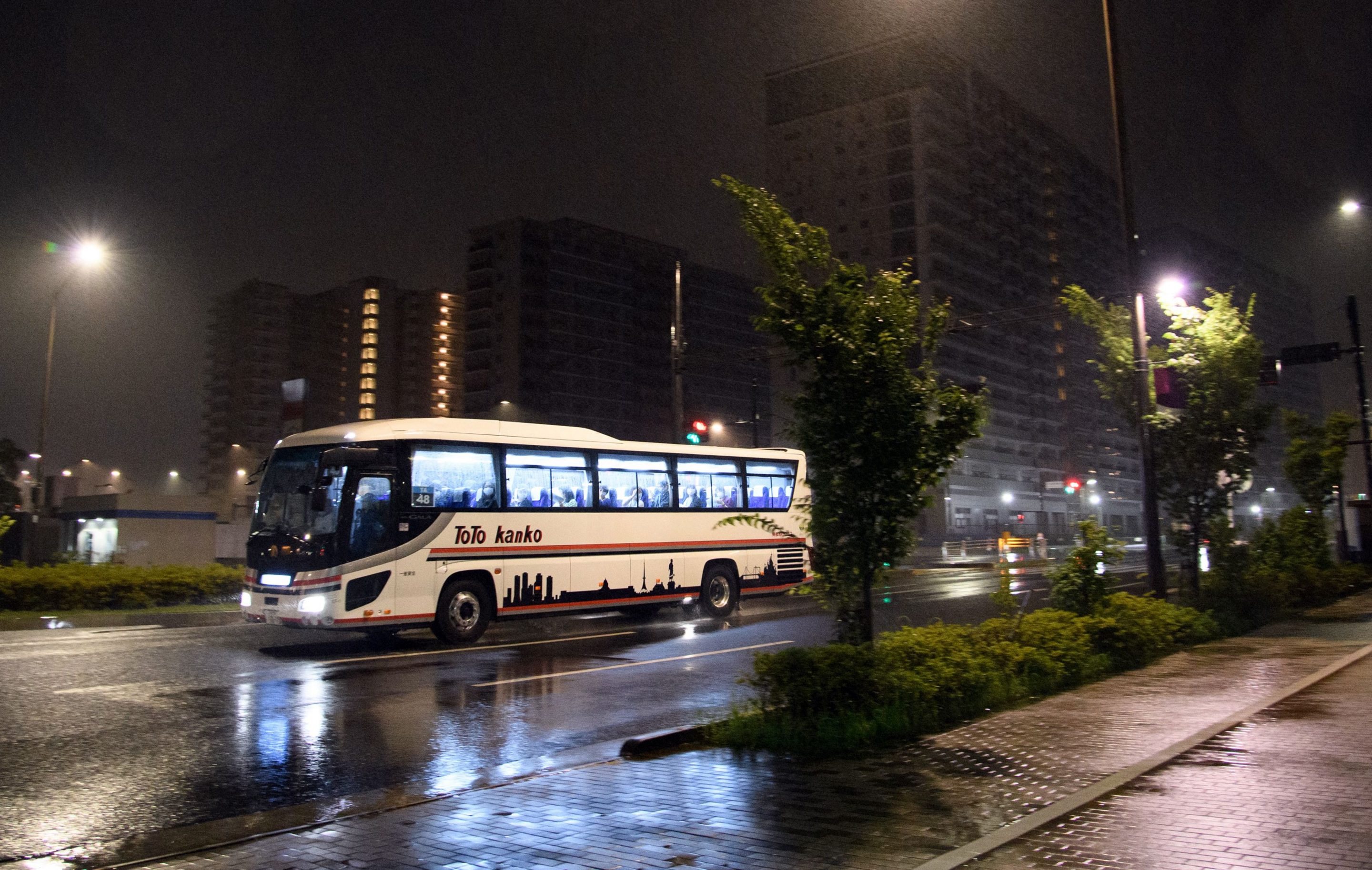 Buses travel near the Olympic and Paralympic Village in Tokyo on June 20, 2021, during a transport operations simulation for the opening and closing ceremonies of the Tokyo 2020 Olympic Games.