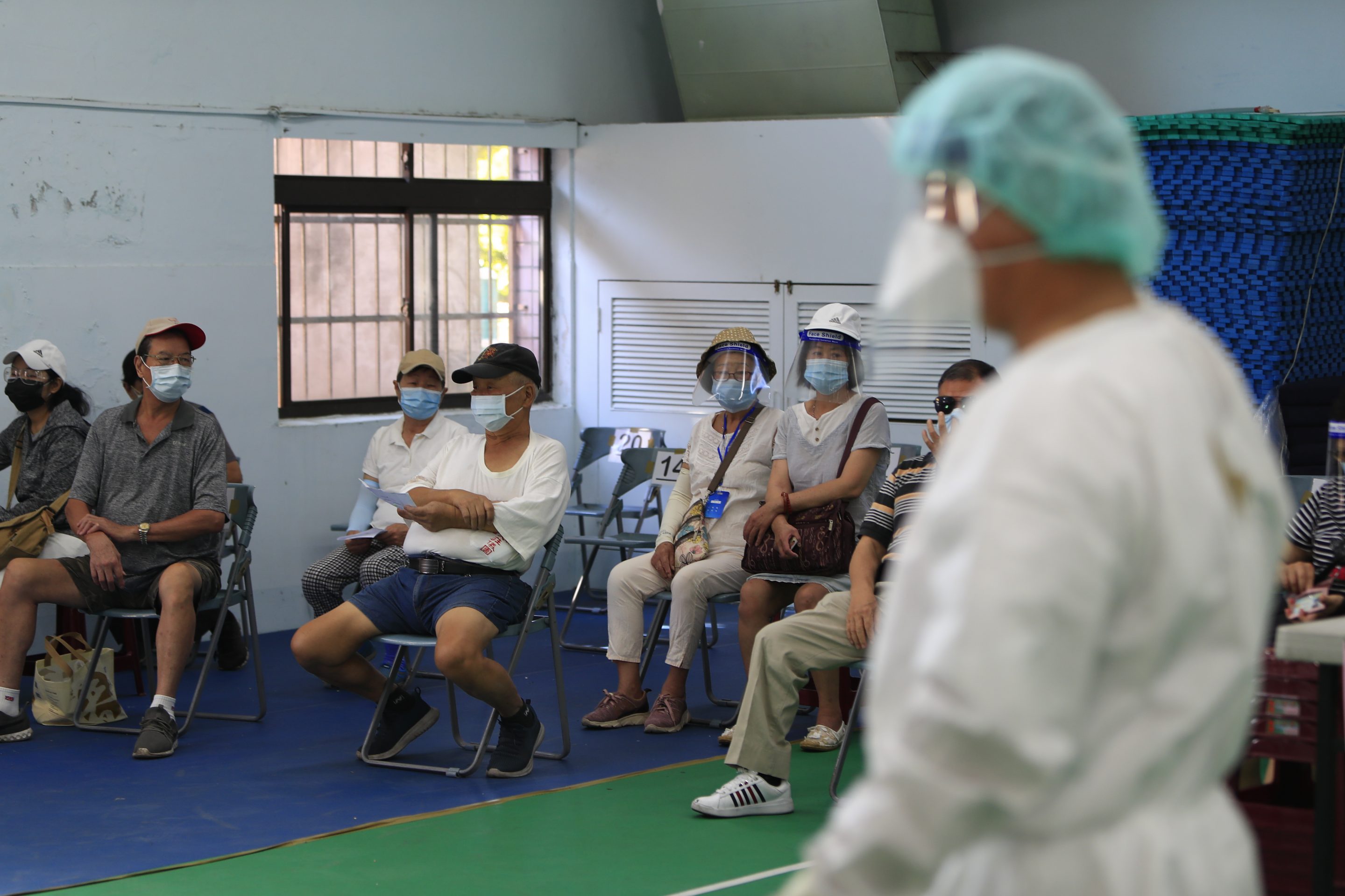 Elderly people and other citizens wait for vaccination against the coronavirus, following an outbreak with a surge in the number of domestic infections and deaths, in Taipei, Taiwan, July 5, 2021. 