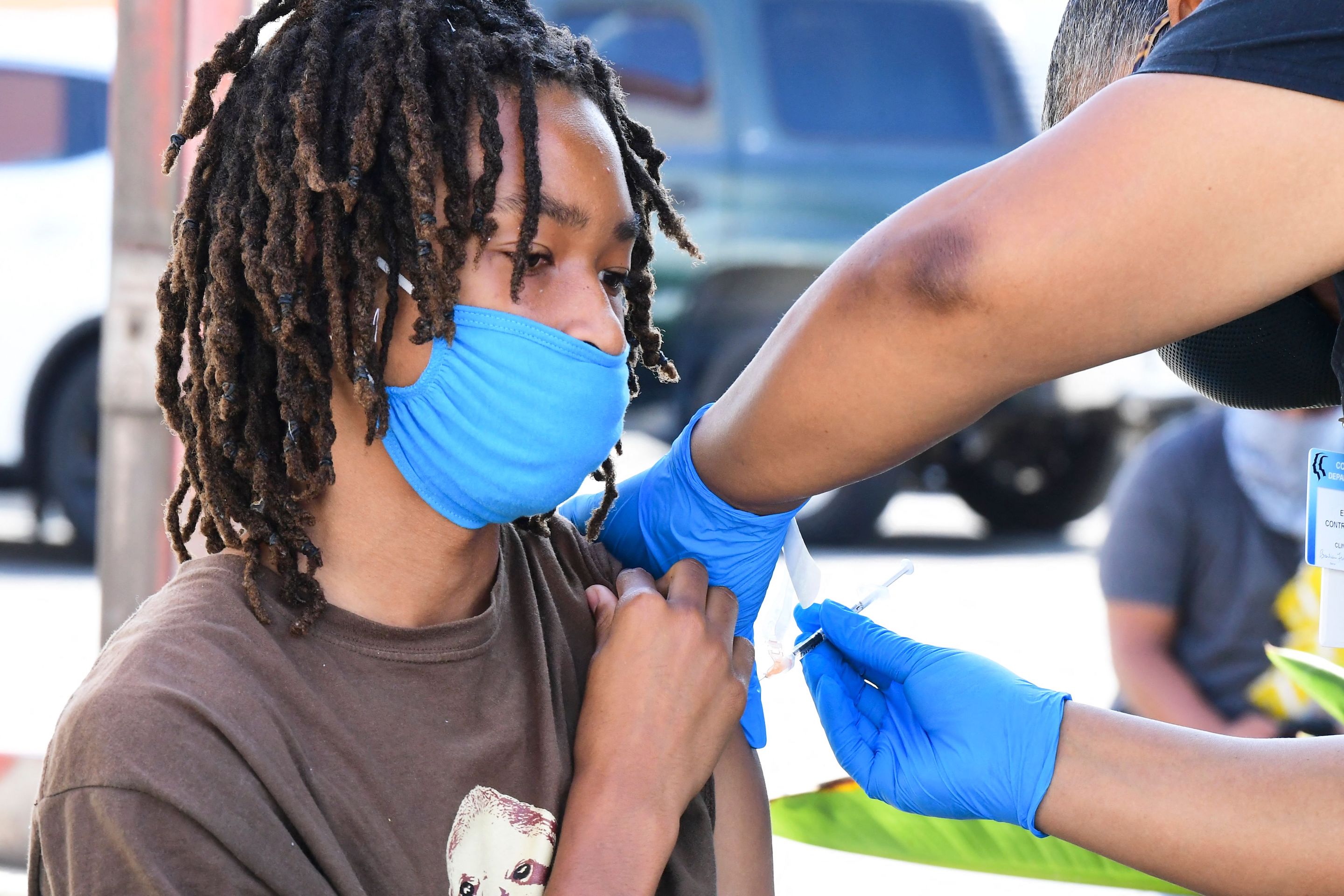 Jacob Alexander, 14, receives her Pfizer Covid-19 vaccine from vocational nurse Eon Walker at a mobile vaccine clinic hosted by Mothers in Action and operated by the Los Angeles County of Public Health on July 16, 2021 in Los Angeles.