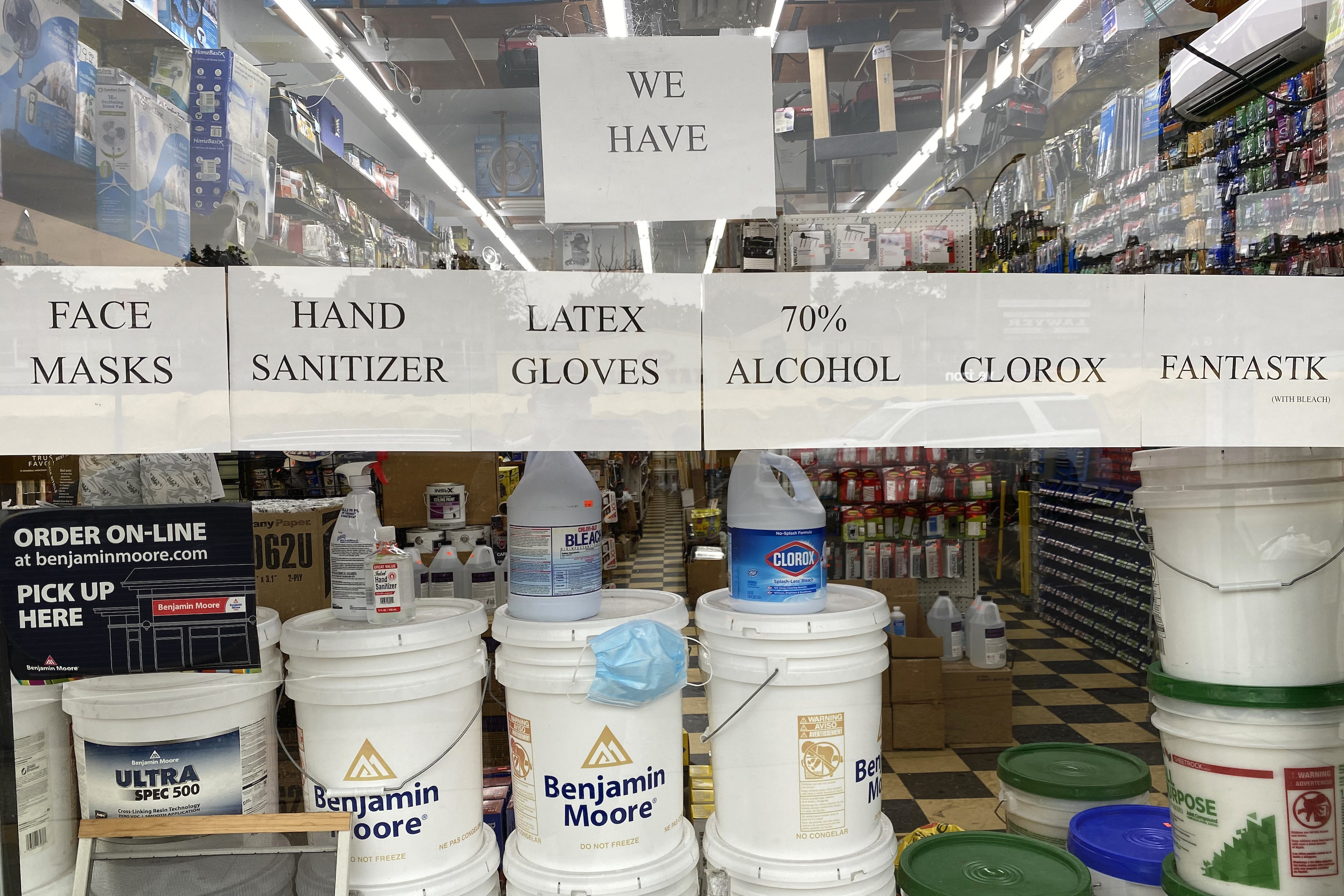 A hardware store in Queens, N.Y., advertises the sale of masks, sanitizer, gloves, and other cleaning products.