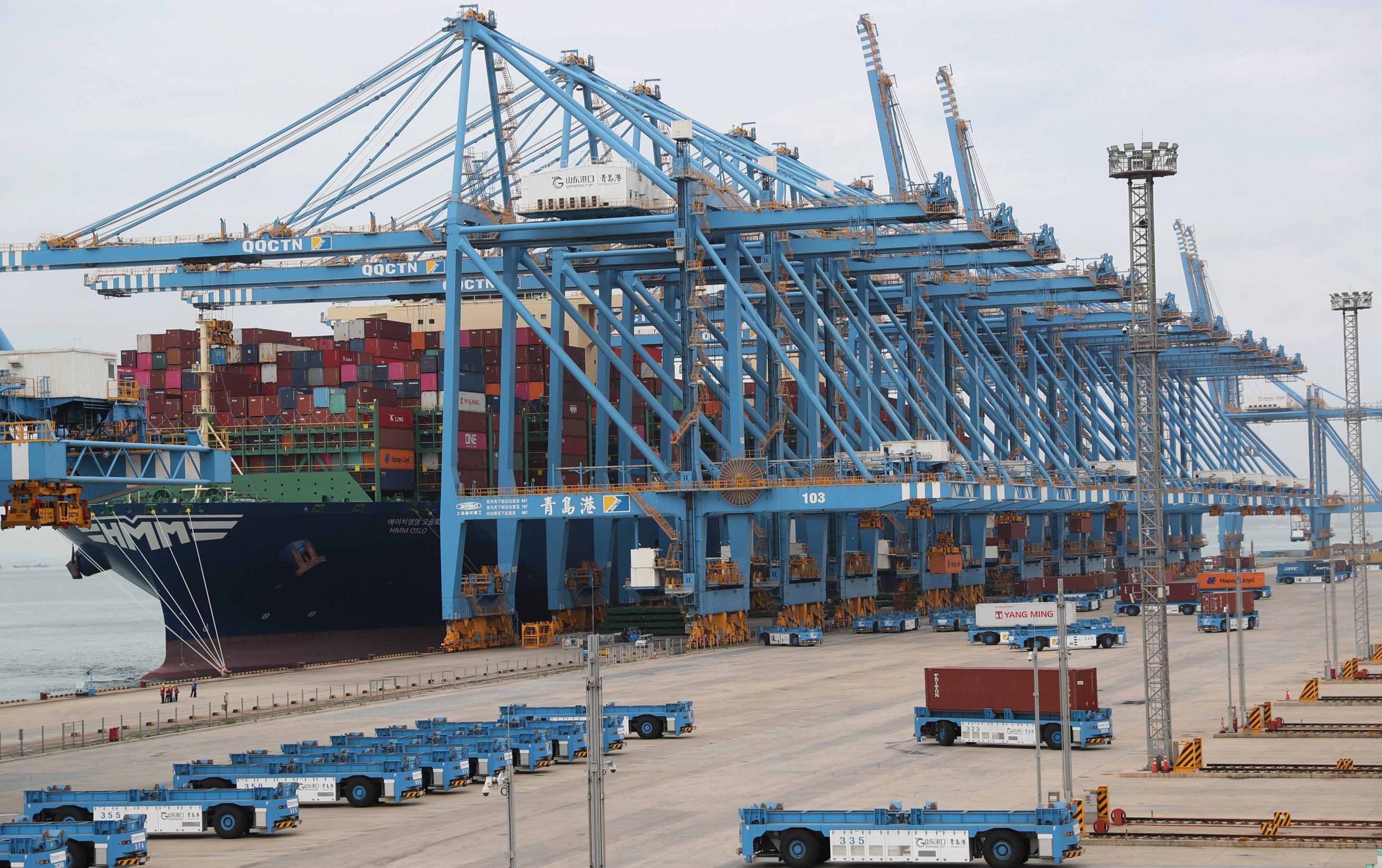 Shipping containers are loaded onto unmanned vehicles at Asia's first fully automated container terminal of Qingdao Port on July 15, 2021 in Qingdao, Shandong, China.