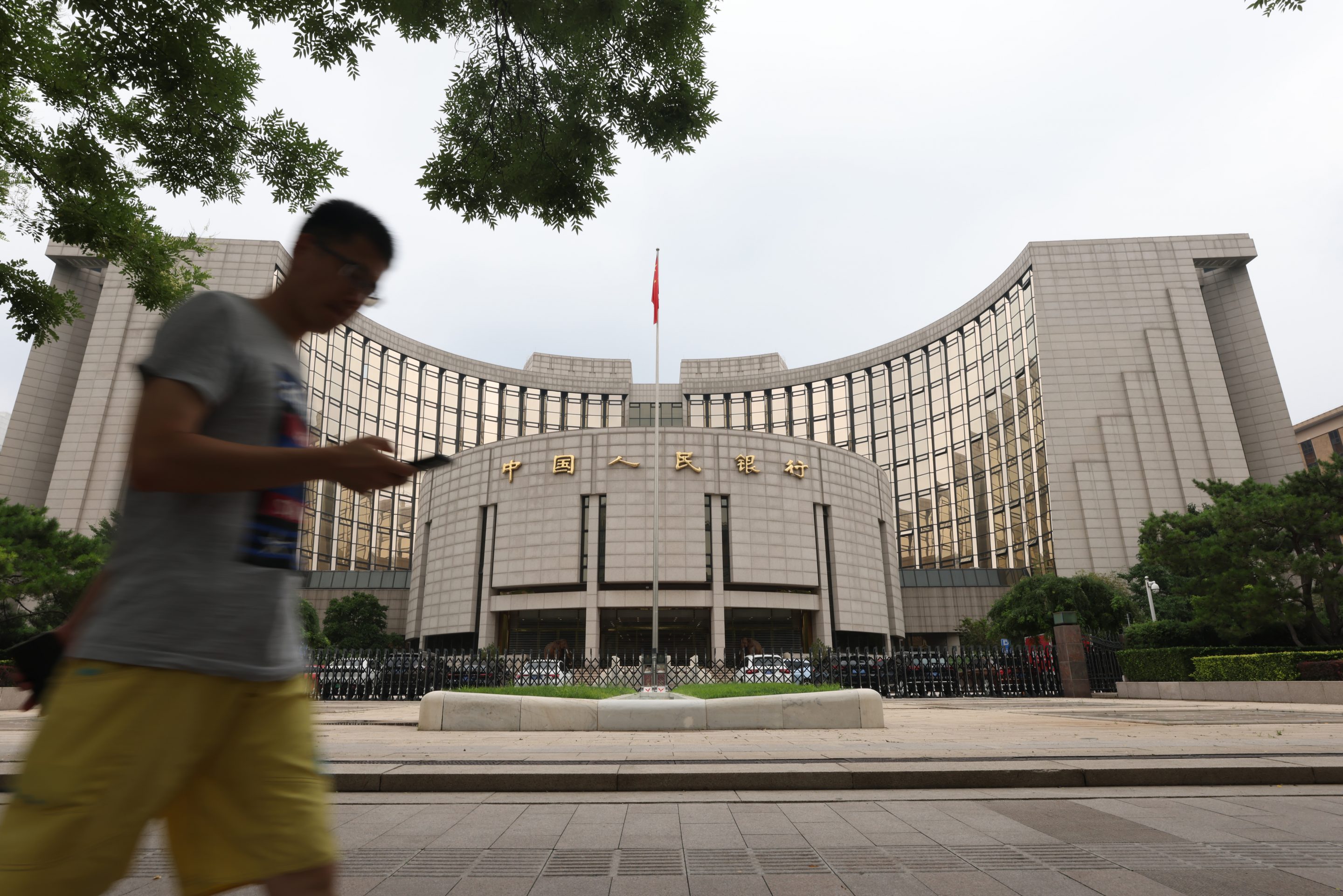 A man walks past the People's Bank of China (PBOC) building on July 20, 2021 in Beijing, China. (Photo by Jiang Qiming/China News Service via Getty Images)