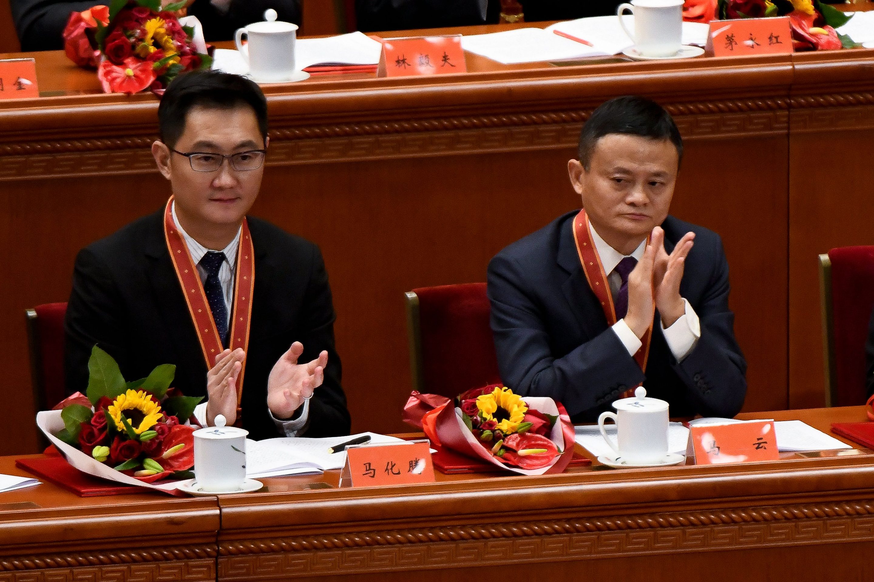 Alibaba cofounder Jack Ma (right) and Tencent Holdings CEO Pony Ma applaud during a celebratory meeting marking the 40th anniversary of China’s “reform and opening up” policy at the Great Hall of the People in Beijing on Dec. 18, 2018.