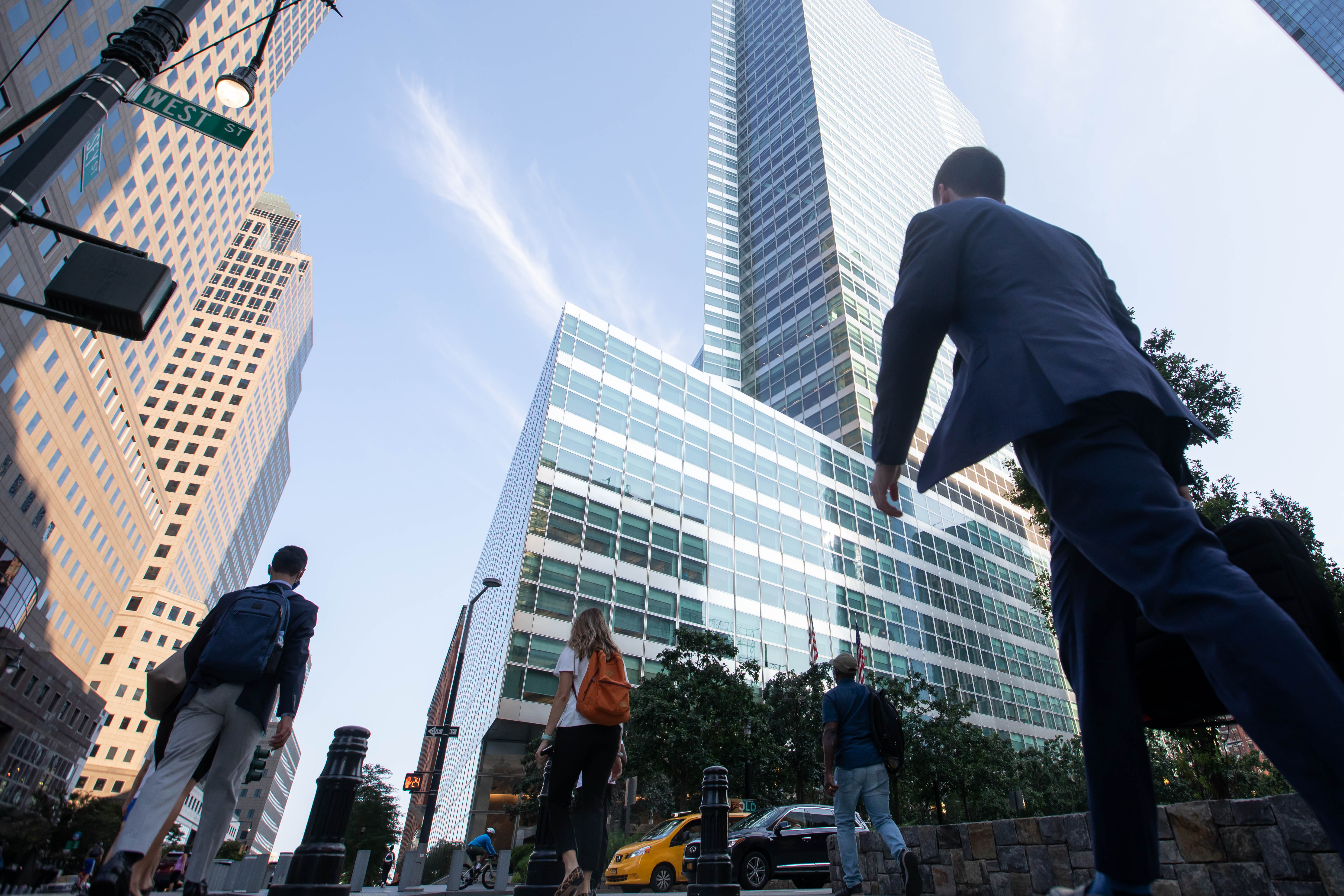 Office workers walk near the Goldman Sachs Group Inc. headquarters in New York on July 22, 2021.