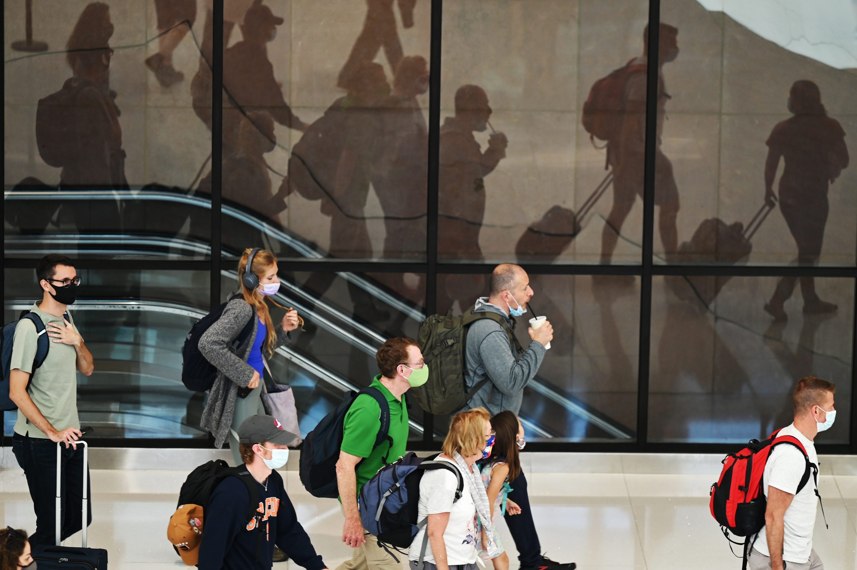 Travelers arrive at the main concourse of Denver International Airport in Denver, Colorado on July 7, 2021.