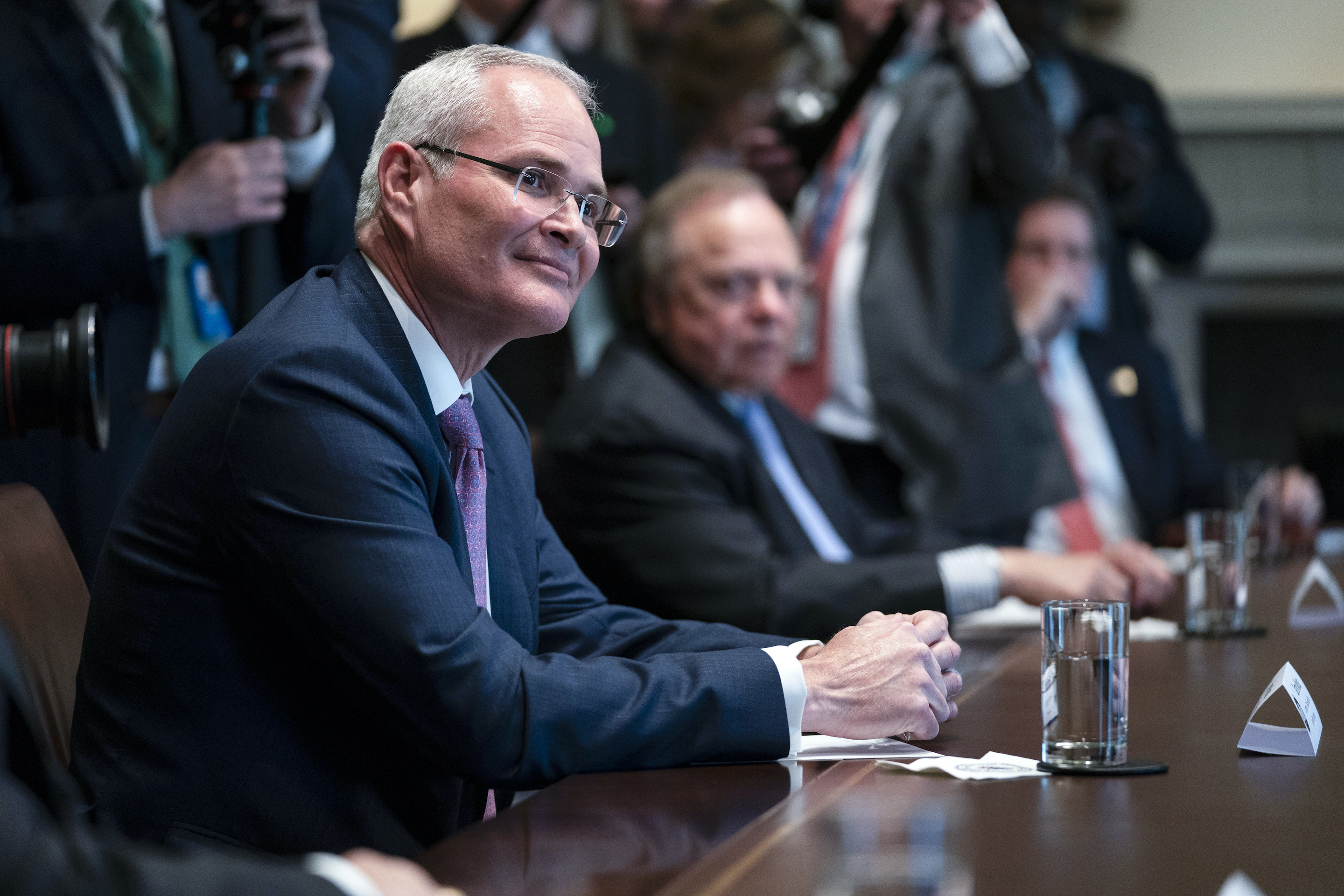 Exxon Mobil CEO Darren Woods listens as President Donald Trump speaks during a meeting with energy sector business leaders in the Cabinet Room of the White House, on April 3, 2020.