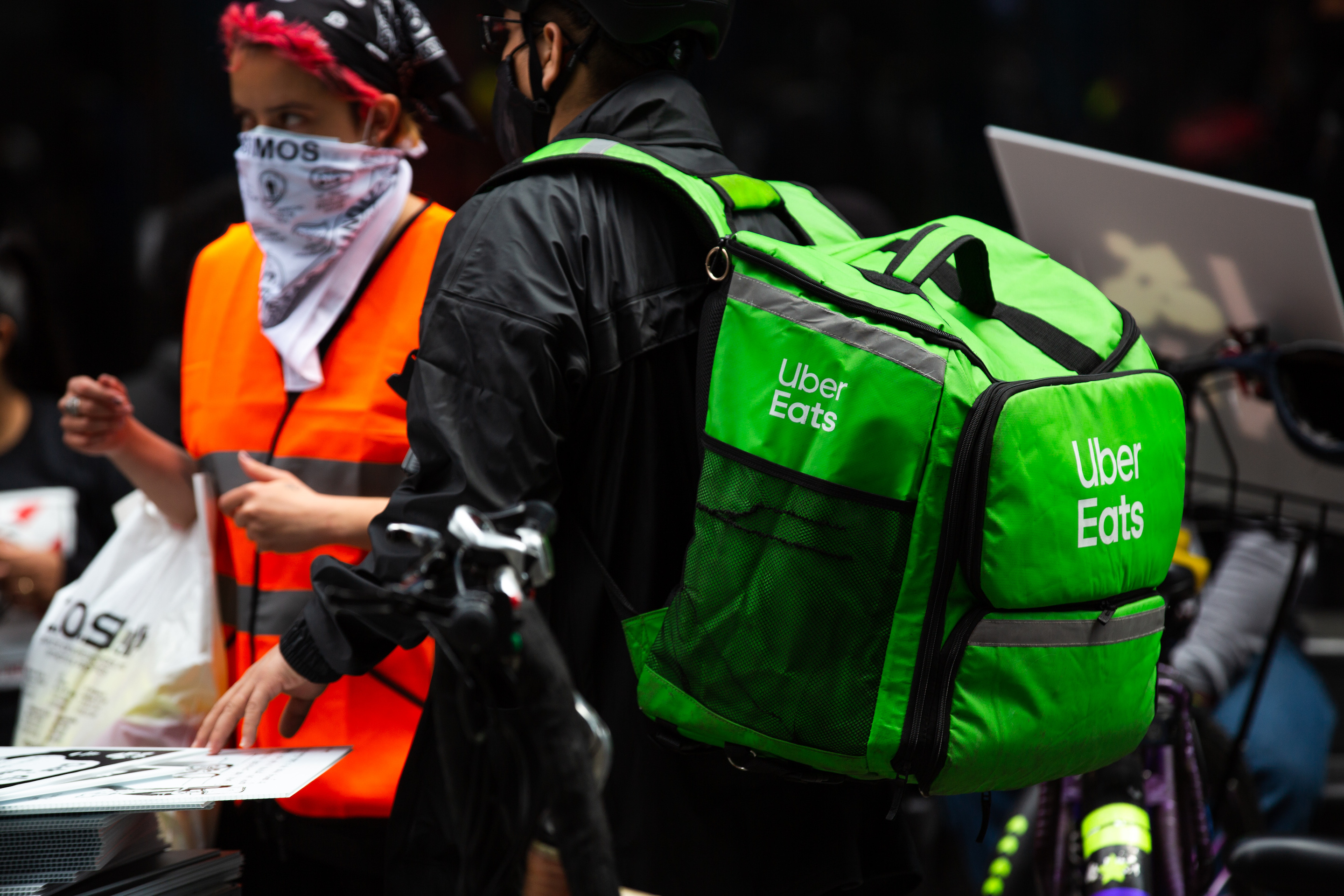 A demonstrator wearing a Uber Eats backpack in Times Square during a march for food delivery workers rights in New York on April 21, 2021.