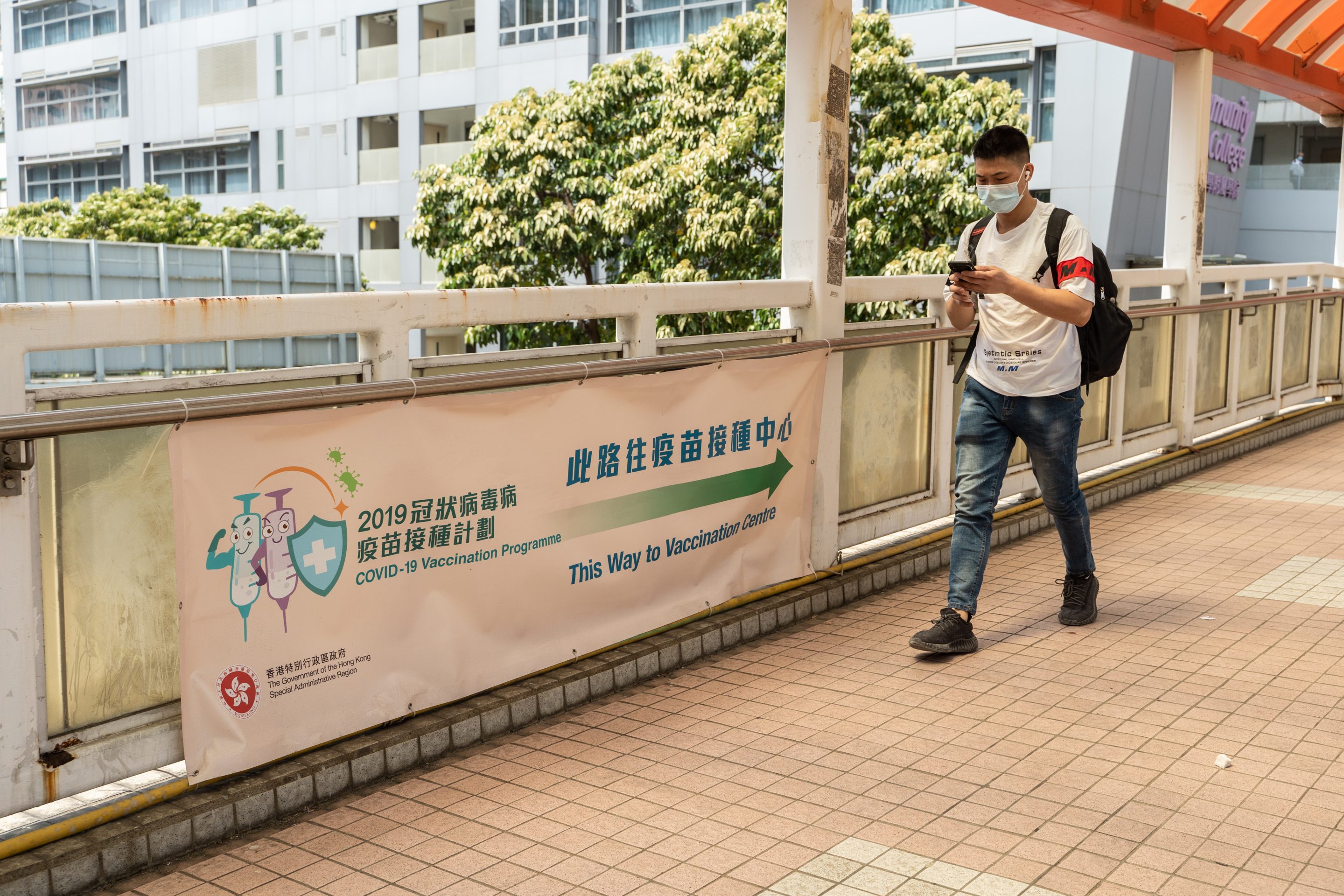 Signage directing visitors to a community vaccination center in Hong Kong, China, on Saturday, April 24, 2021.