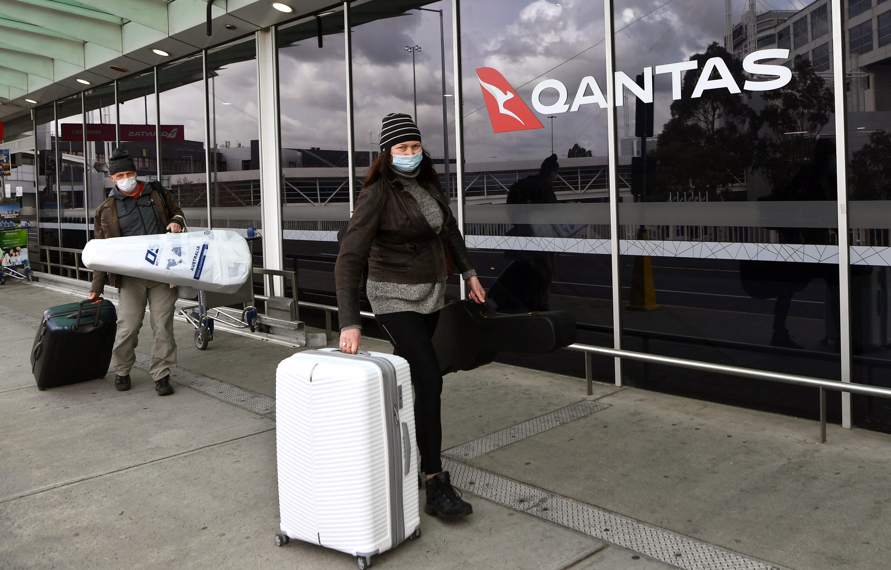 Travellers arrive at a deserted Qantas terminal at Melbourne Airport on August 26, 2021 as Australian airline Qantas posted more than 1 billion USD in annual losses, after what it described as a "diabolical" year caused by pandemic travel restrictions. (Photo by William WEST / AFP) (Photo by WILLIAM WEST/AFP via Getty Images)
