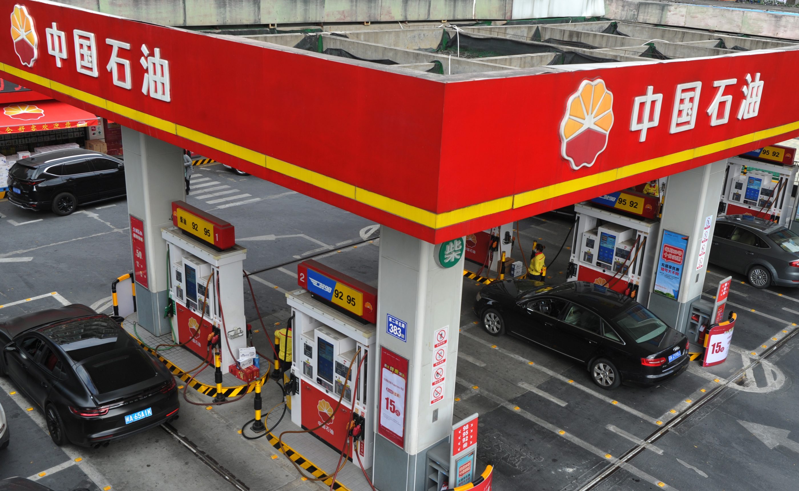 Employees refuel vehicles at a gas station of China National Petroleum Corporation (PetroChina) on December 3, 2020 in Fuzhou, Fujian, China.