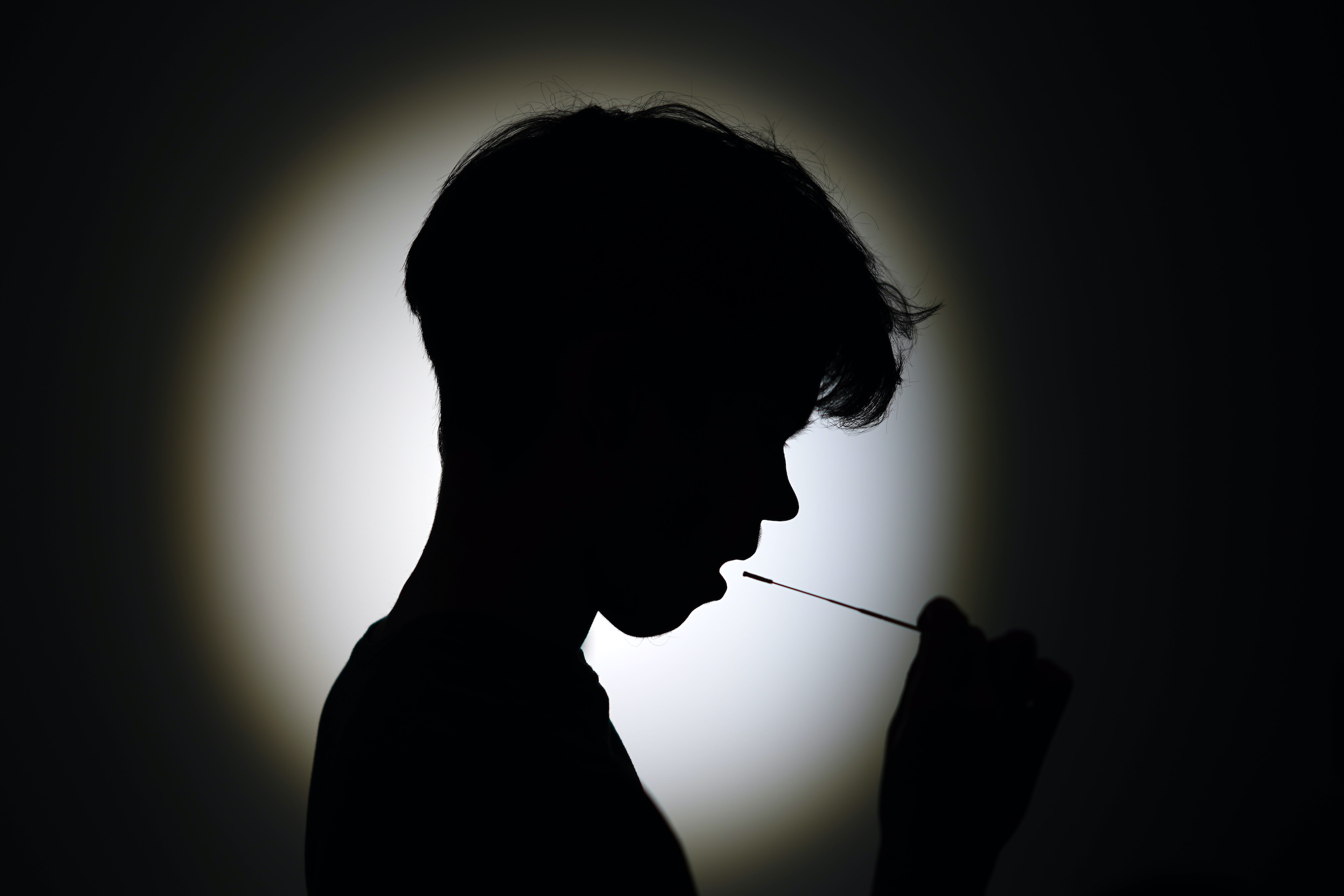 A teenage schoolboy poses as he takes a NHS step-by-step coronavirus Covid-19 (Rapid Antigen Test) lateral flow home test on May 13, 2021 in Knutsford, England.