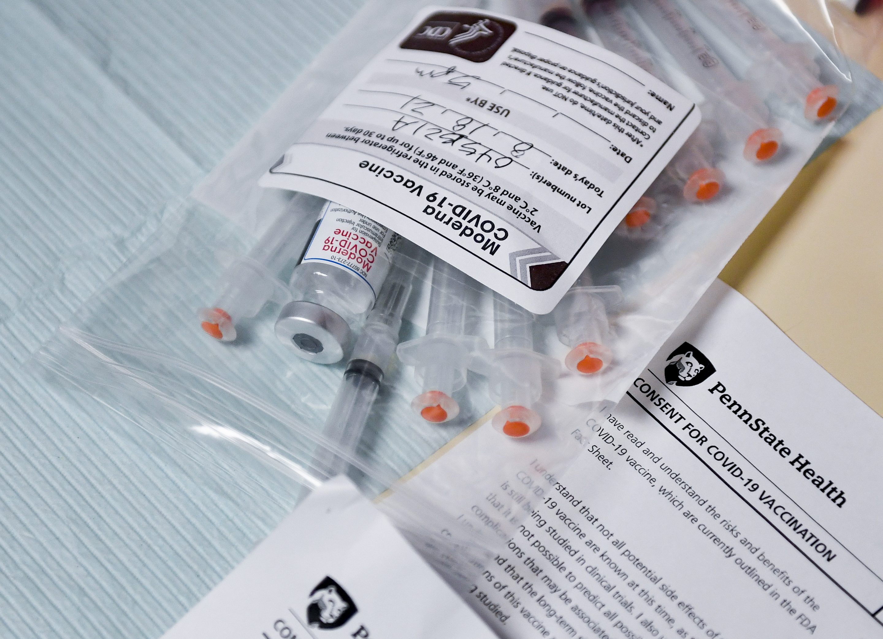 Syringes and a vial of Moderna COVID-19 vaccine.