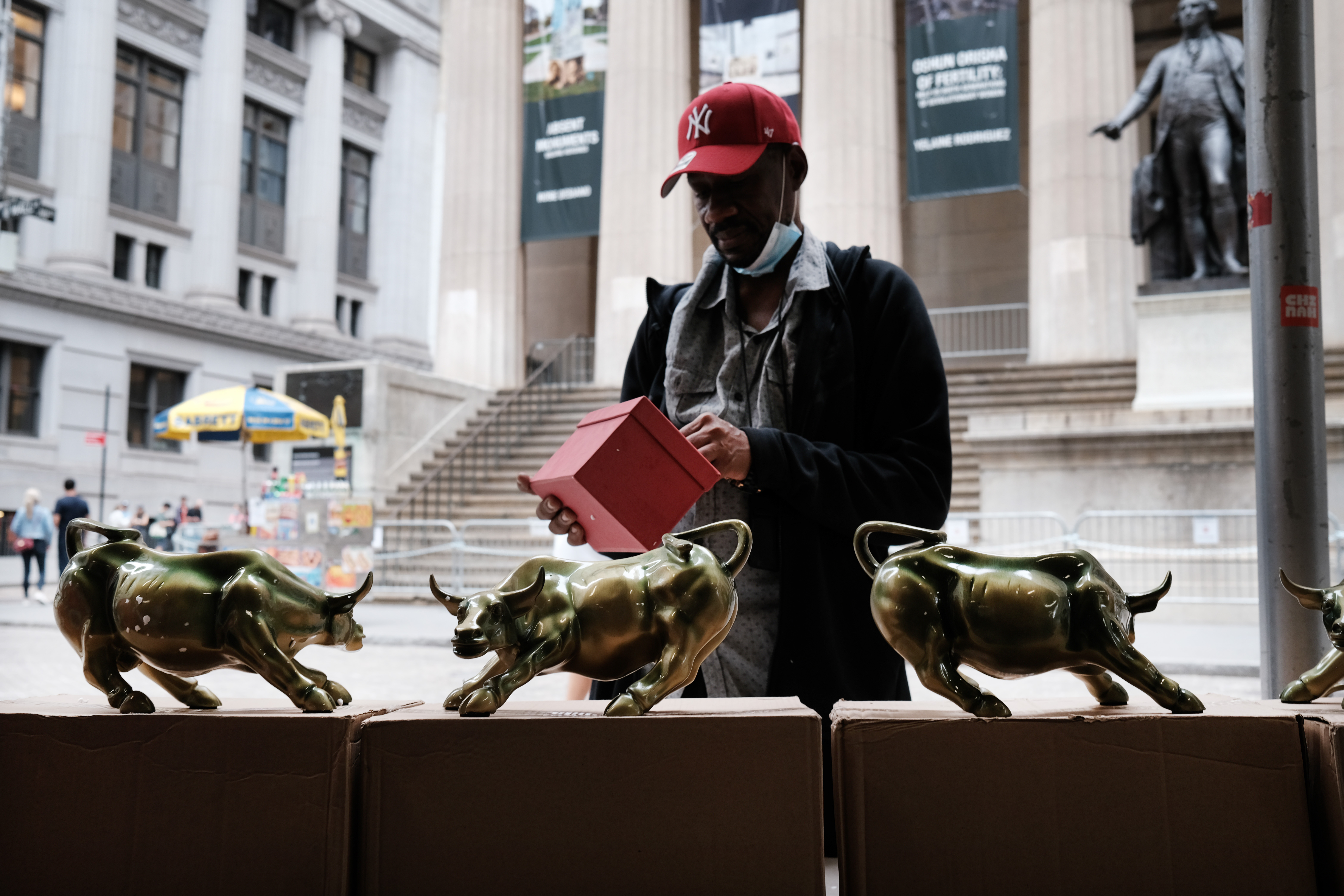 A vendor sells replicas of the Wall Street Bull outside of the New York Stock Exchange (NYSE) in New York City. There's been not much buying of actual stocks lately. The S&P 500 has been flat over the past month.