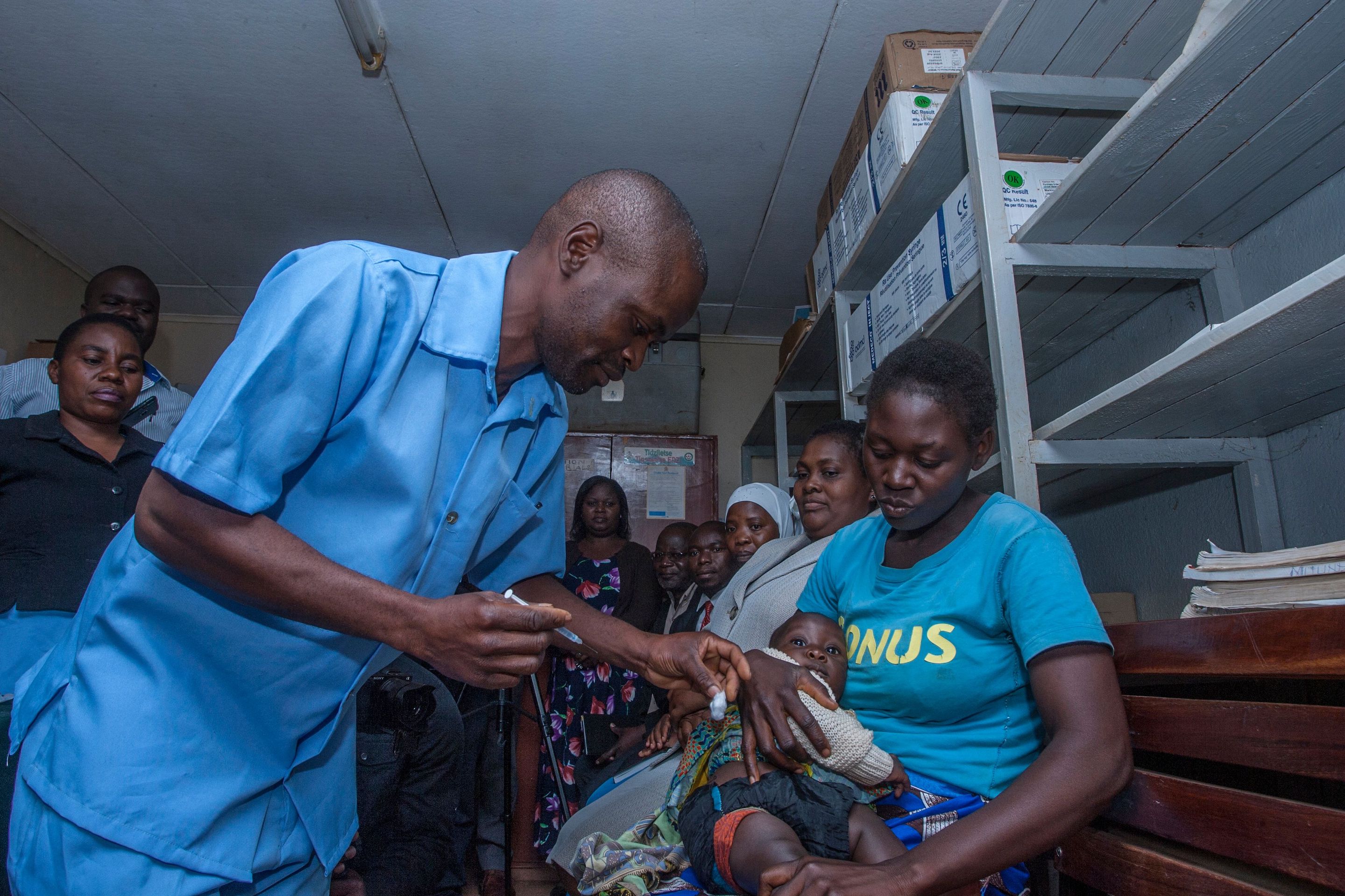 A health surveillance Assistant prepares to give a dose of the Malaria Vaccine into the first recipient on April 23, 2019 at Mitundu Community hospital in Malawi's capital district.