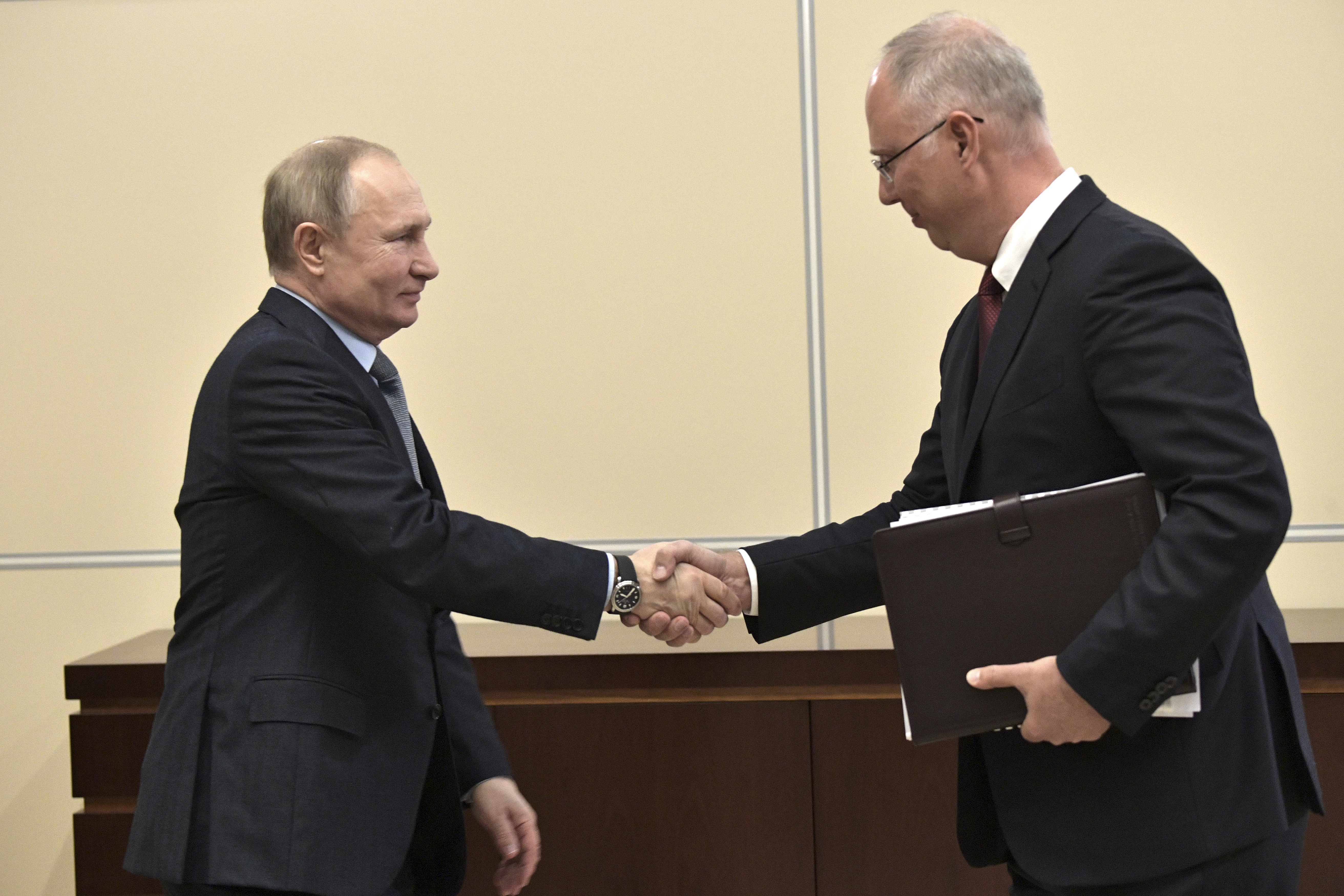 JANUARY 17, 2020: Russia's President Vladimir Putin (L) and Russian Direct Investment Fund CEO Kirill Dmitriev shake hands during a meeting at the Moscow Kremlin.