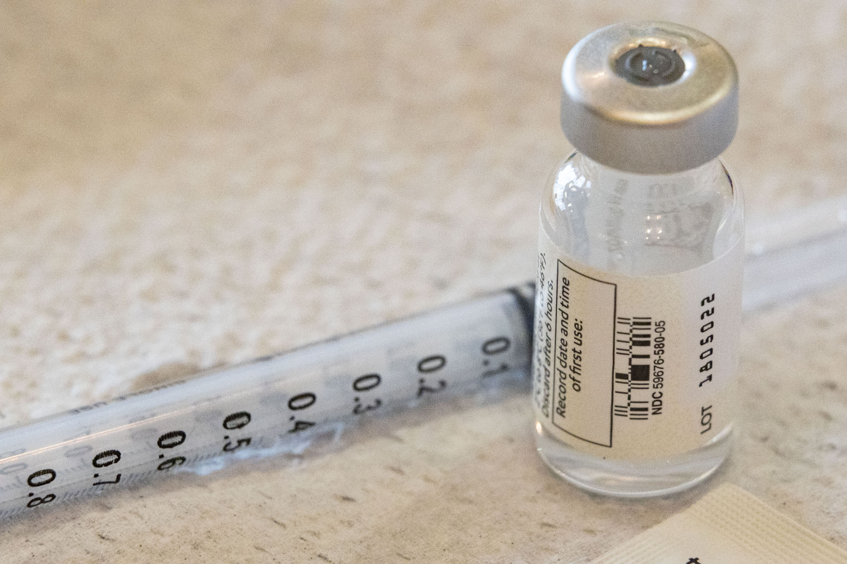 Vial of the COVID-19 vaccine lies next to a syringe during the vaccination in Riggleman Hall in Charleston, West Virginia.