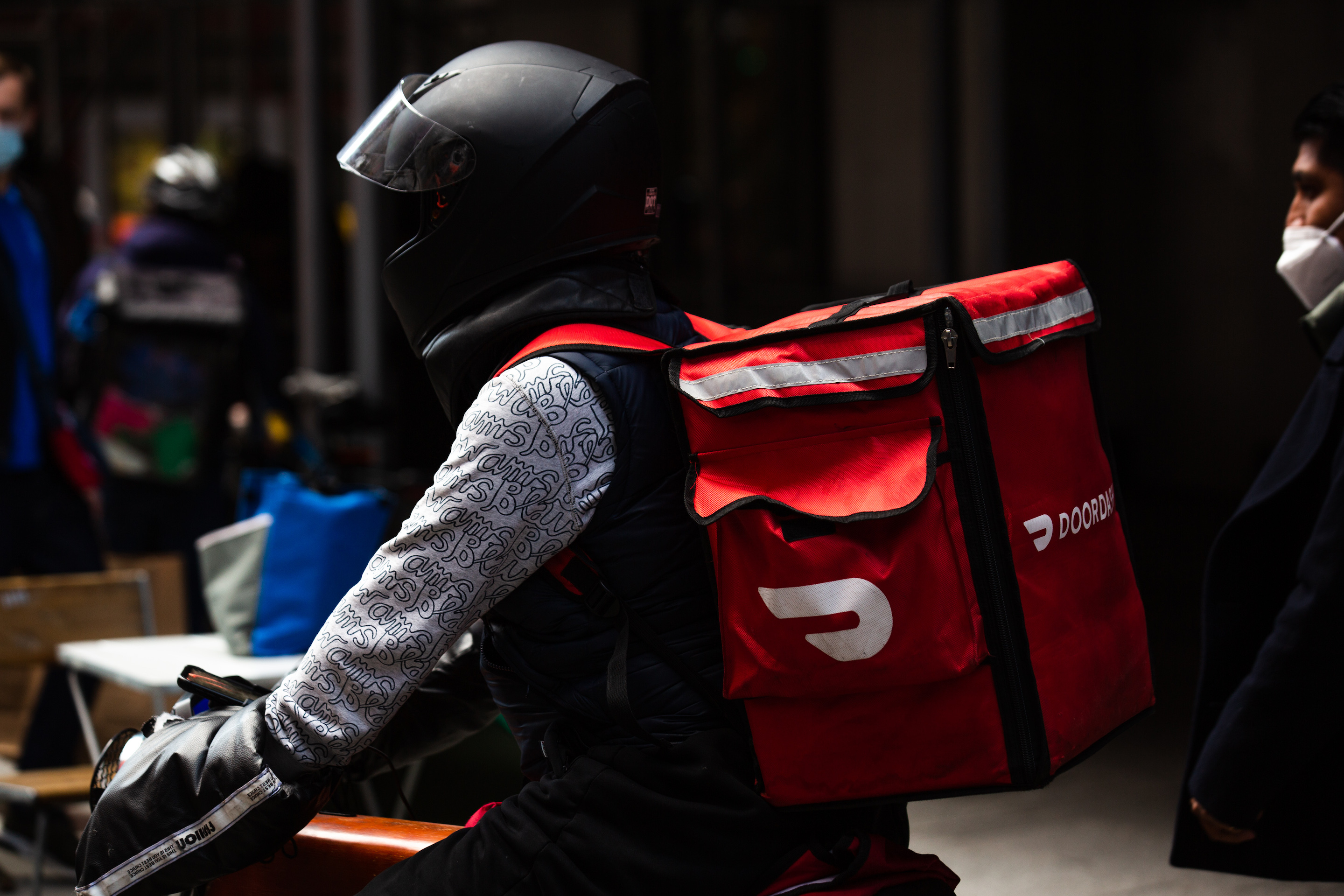 A demonstrator wearing a Doordash backpack in Times Square during a march for food delivery workers rights in New York on Wednesday, April 21, 2021.